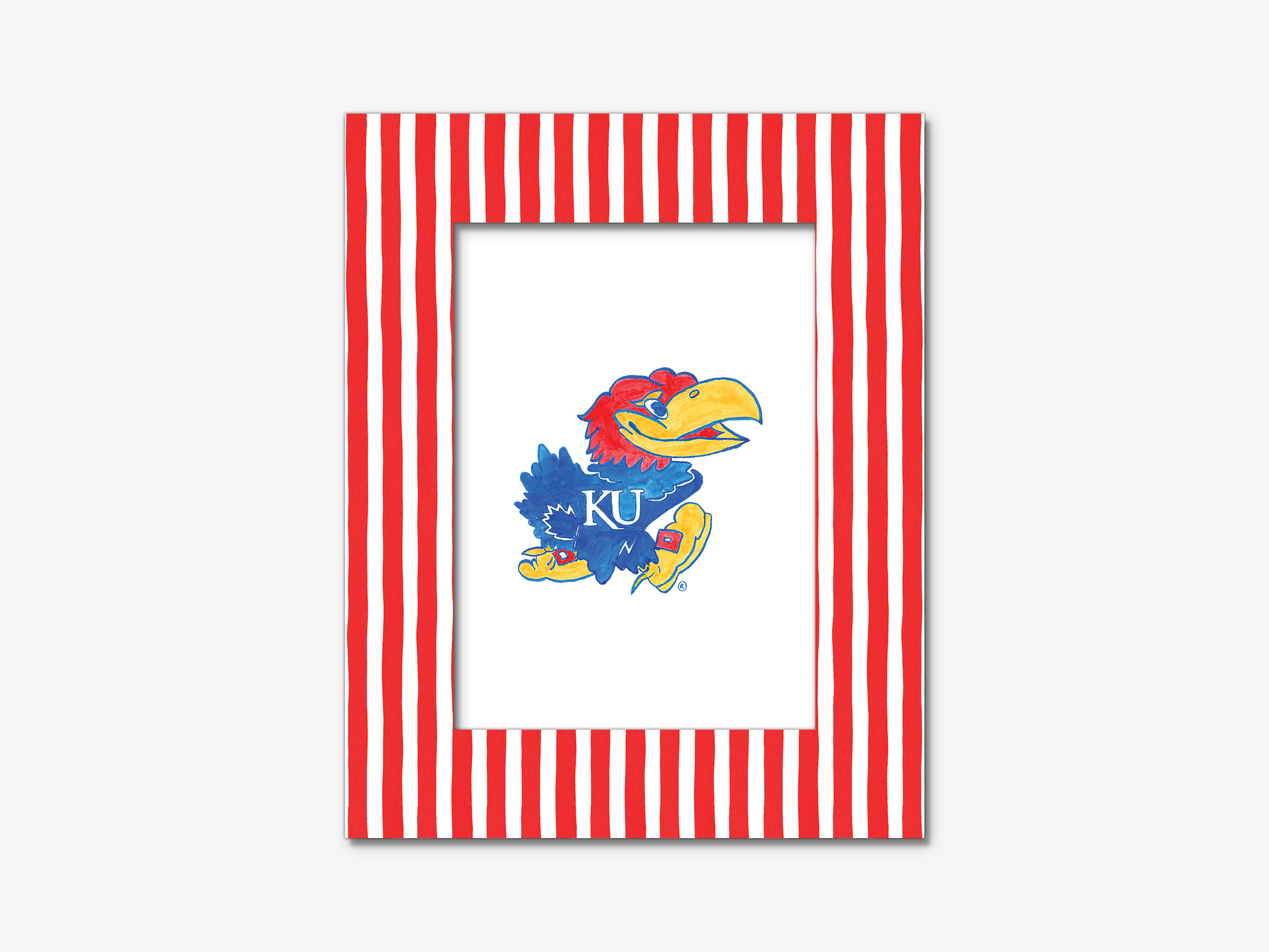 A framed picture of a bird, likely a bird of prey, with a red and white striped border.