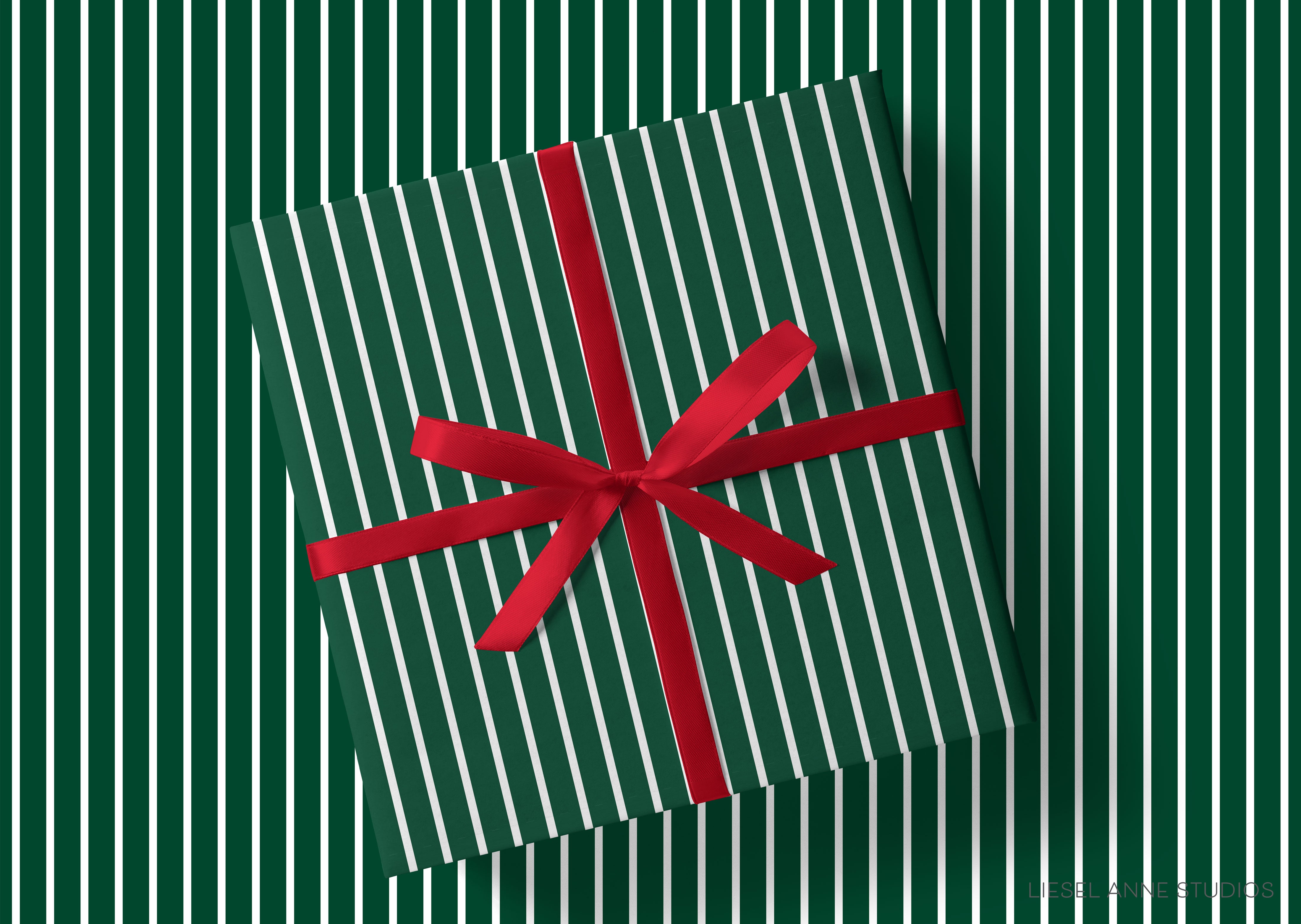 A green gift box with a red ribbon tied around it, placed on a background of green and white striped patterns.