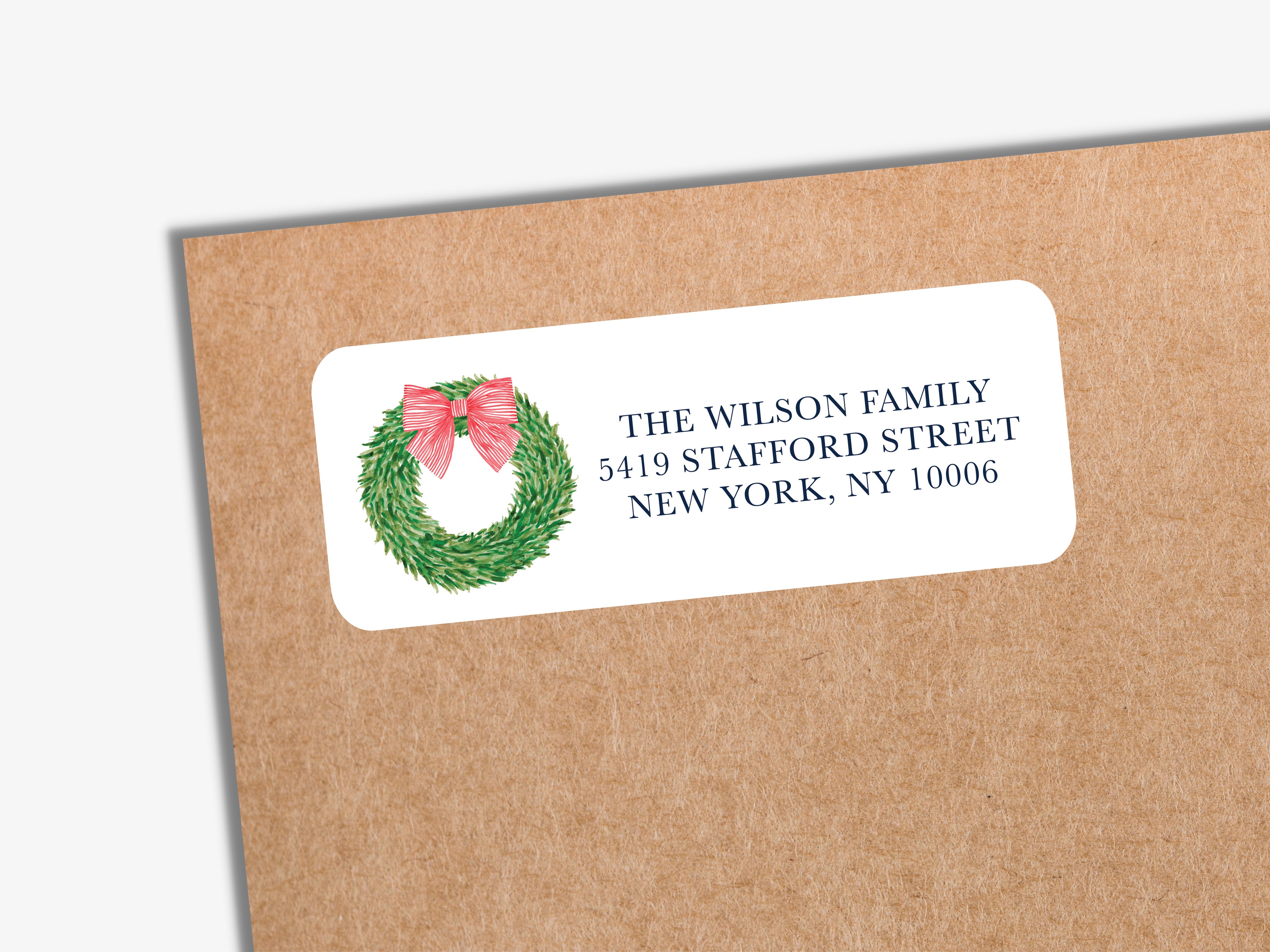 A white envelope label with a wreath design and text on it.