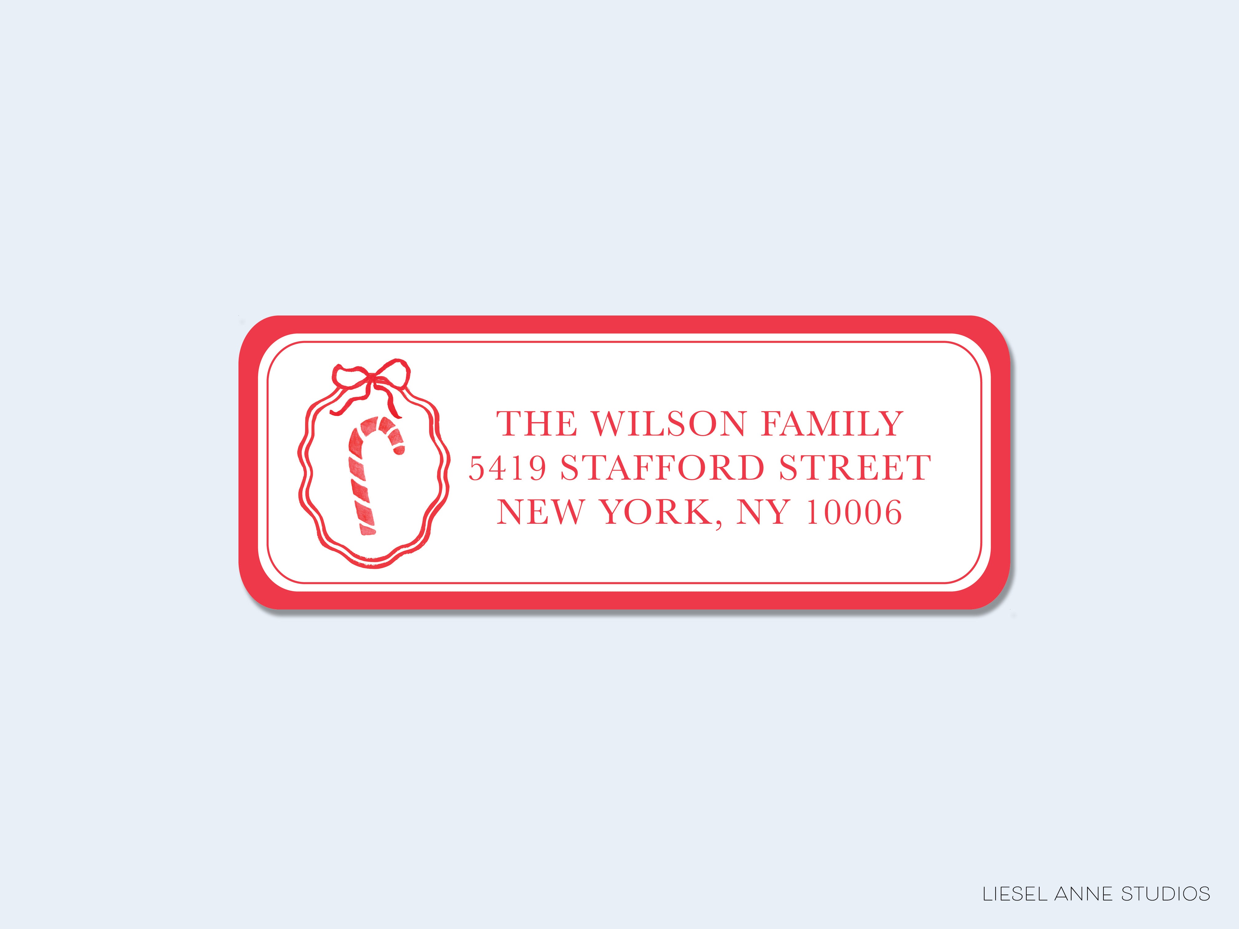 A red and white rectangular address label for "The Wilson Family" located at "5419 Stafford Street, New York, NY 10006".