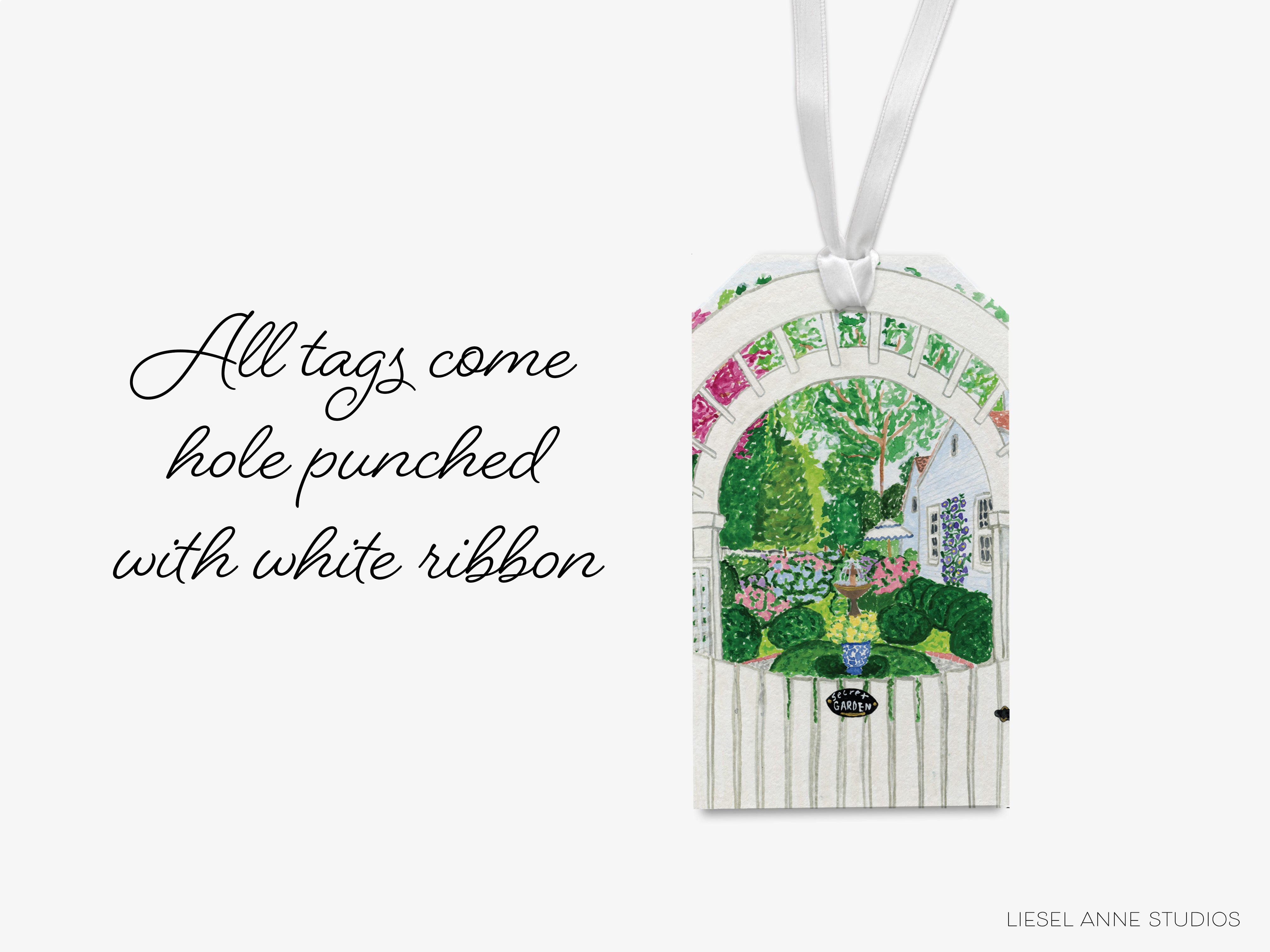 A white ribbon tag with a garden scene printed on it, hanging against a white background.
