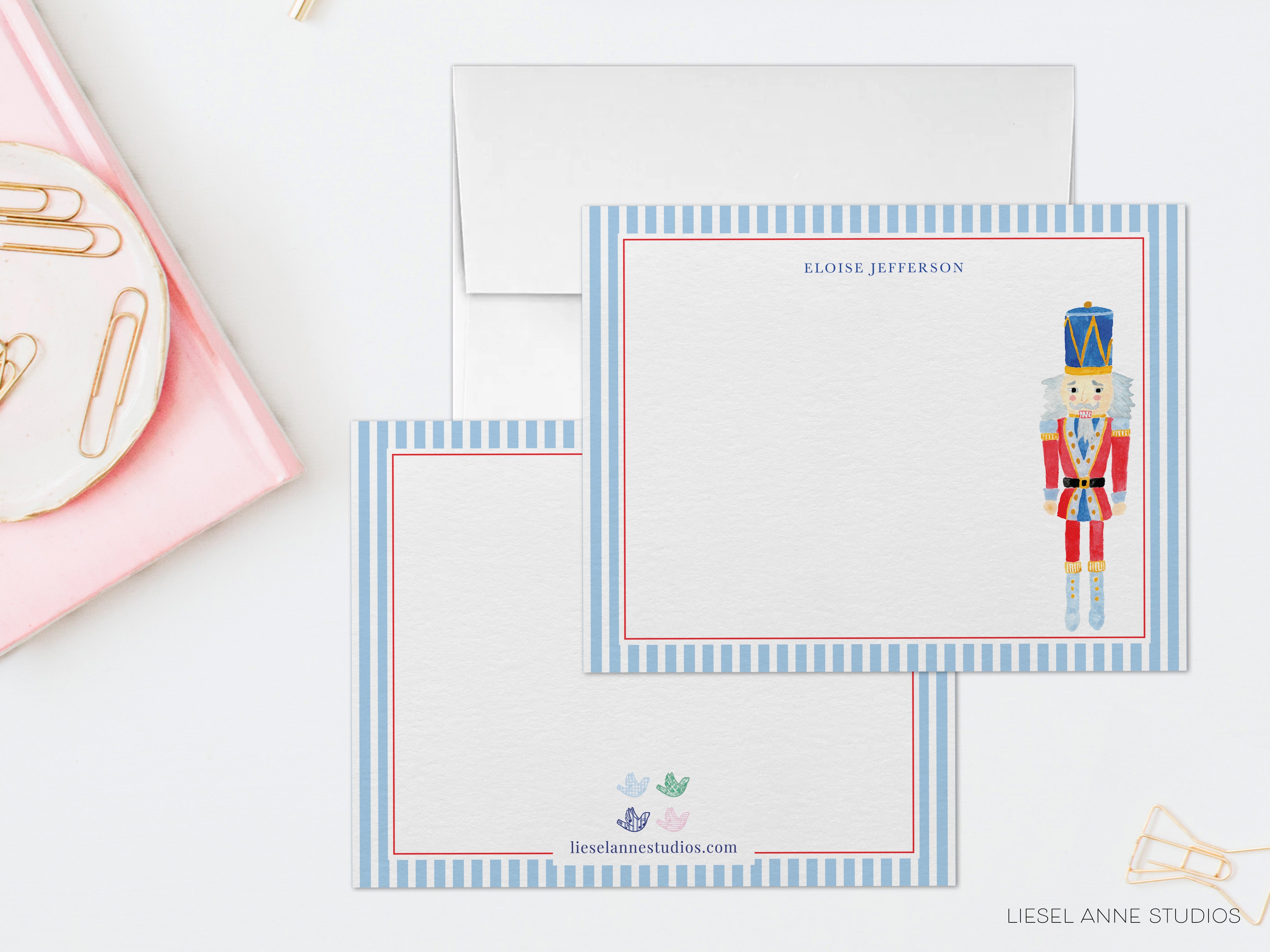 two blank cards with a nutcracker illustration on them, placed on a white surface.