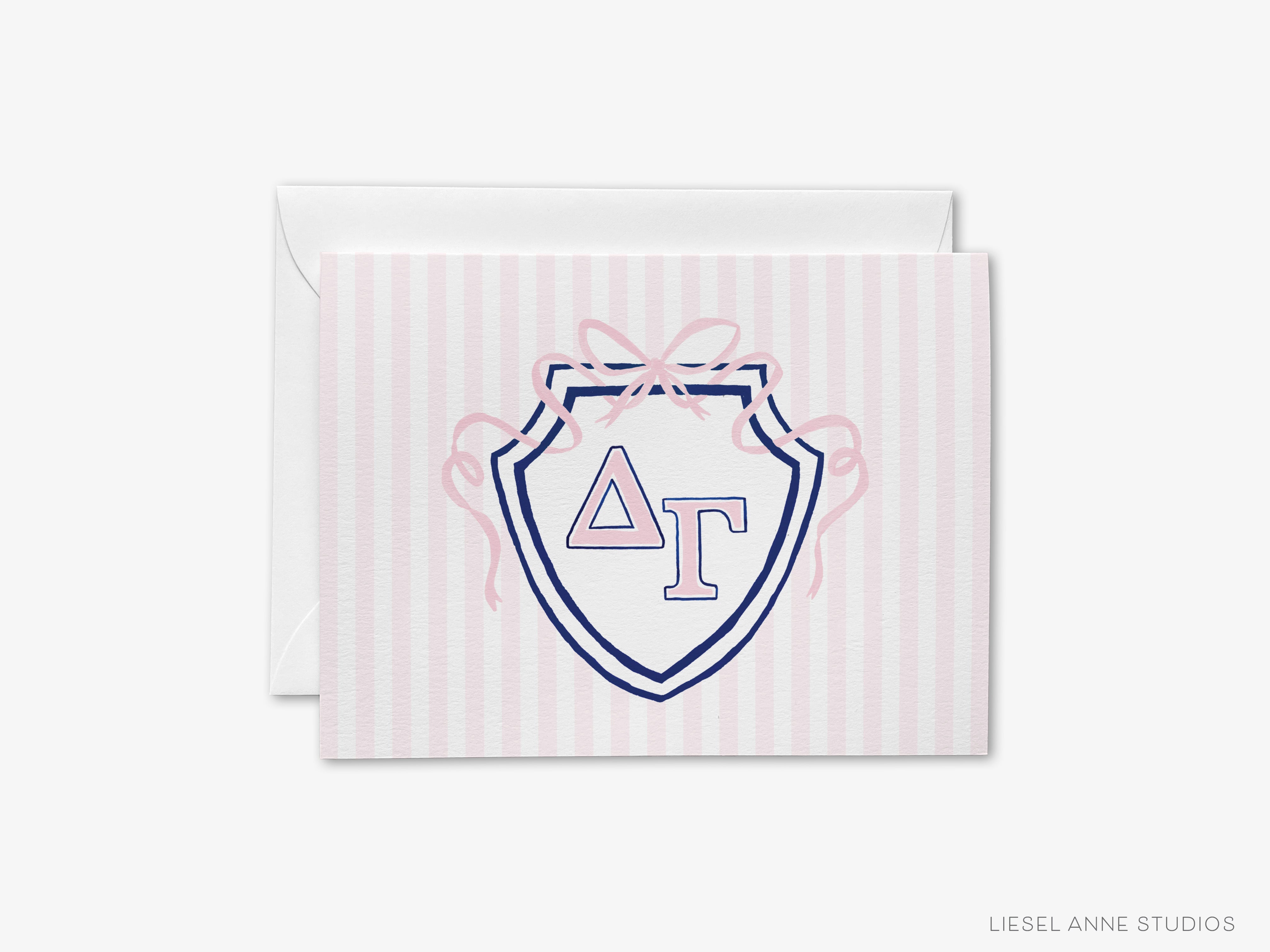 A greeting card with a pink and white striped background and a shield-shaped design featuring the letters 'ΔΟ' in the center.