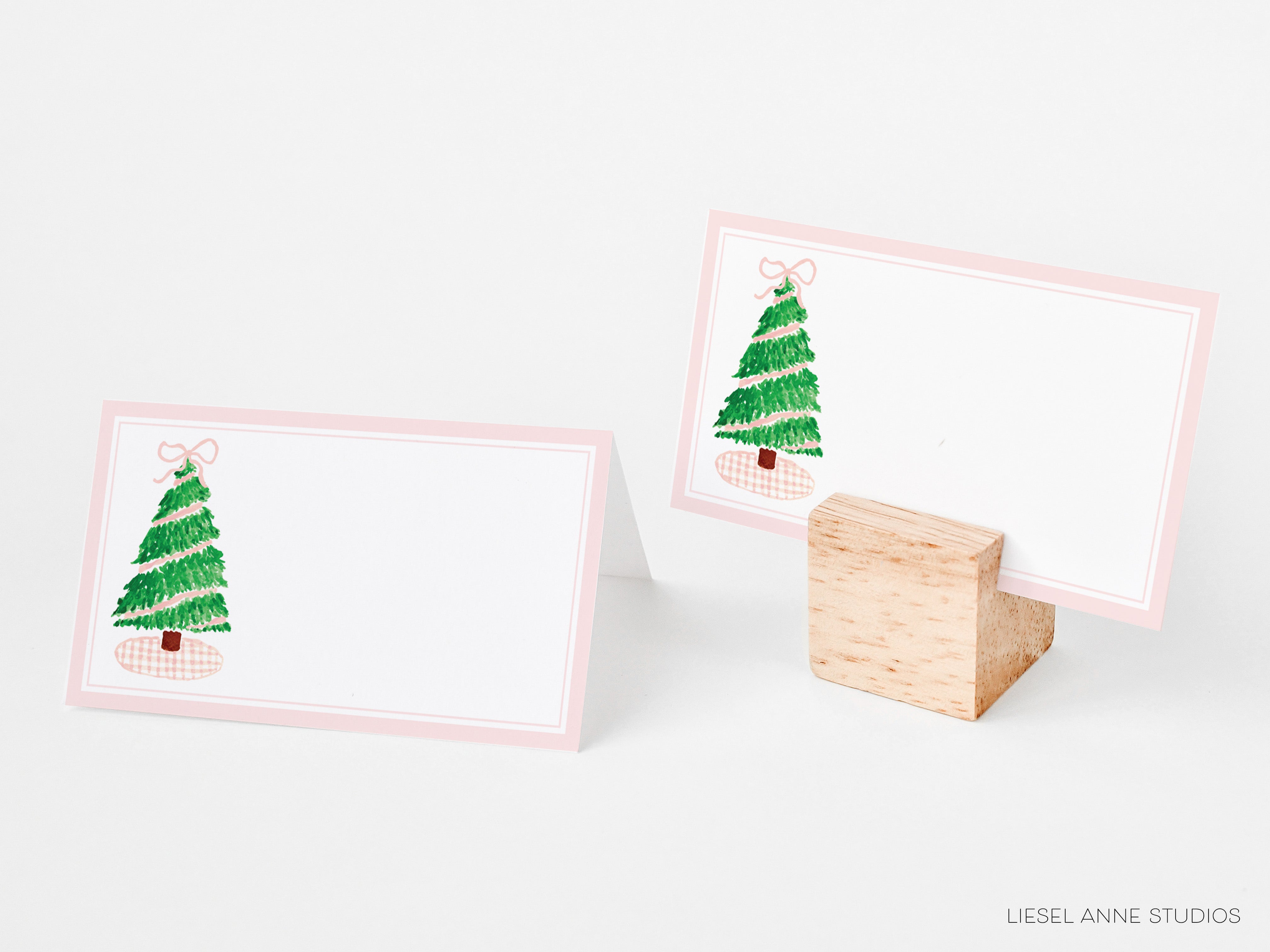 two place cards with a Christmas tree design on them, placed on a white background.