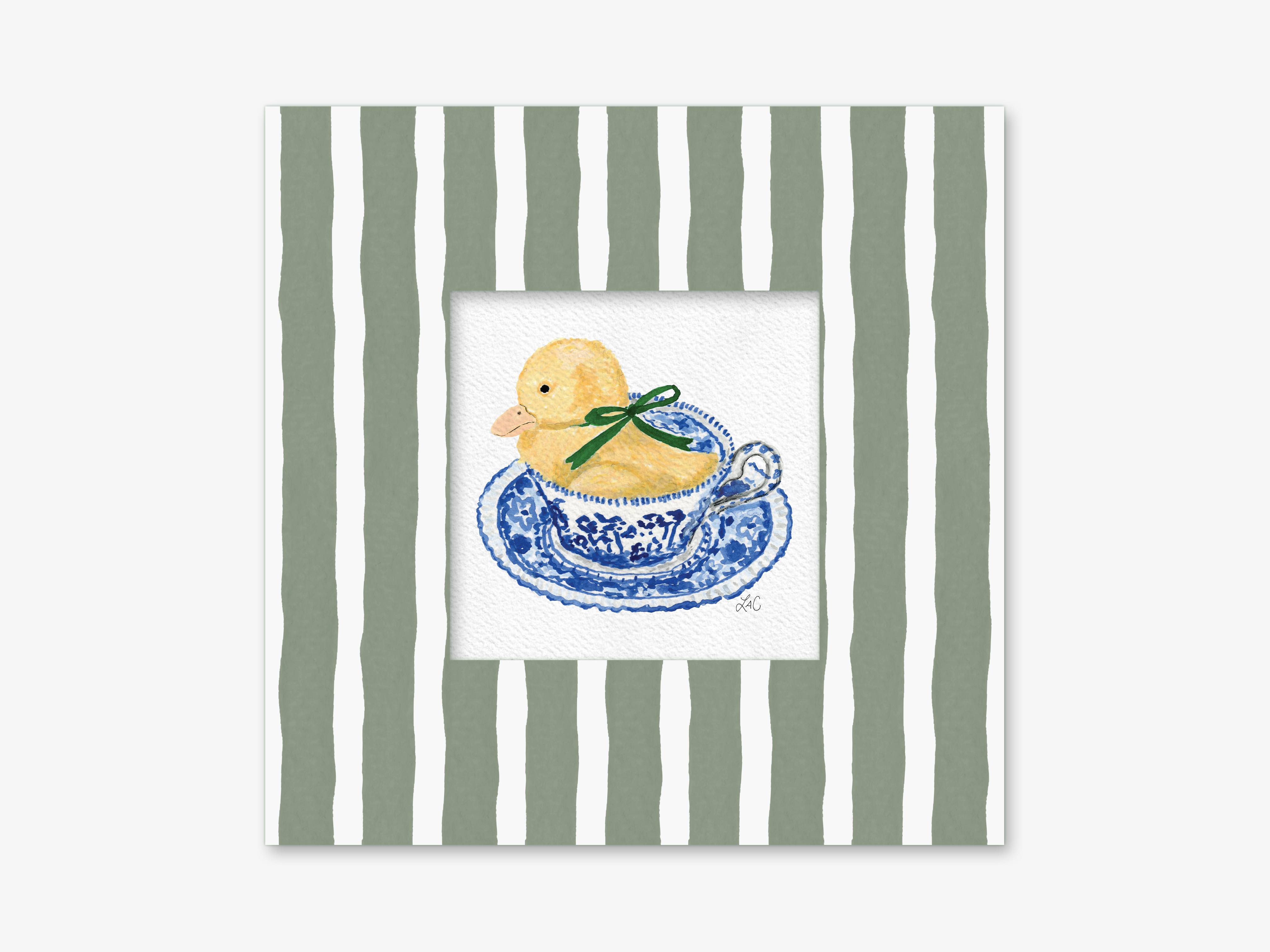 A yellow duck sitting in a blue and white teacup with a green ribbon around it, set against a striped green and white background.