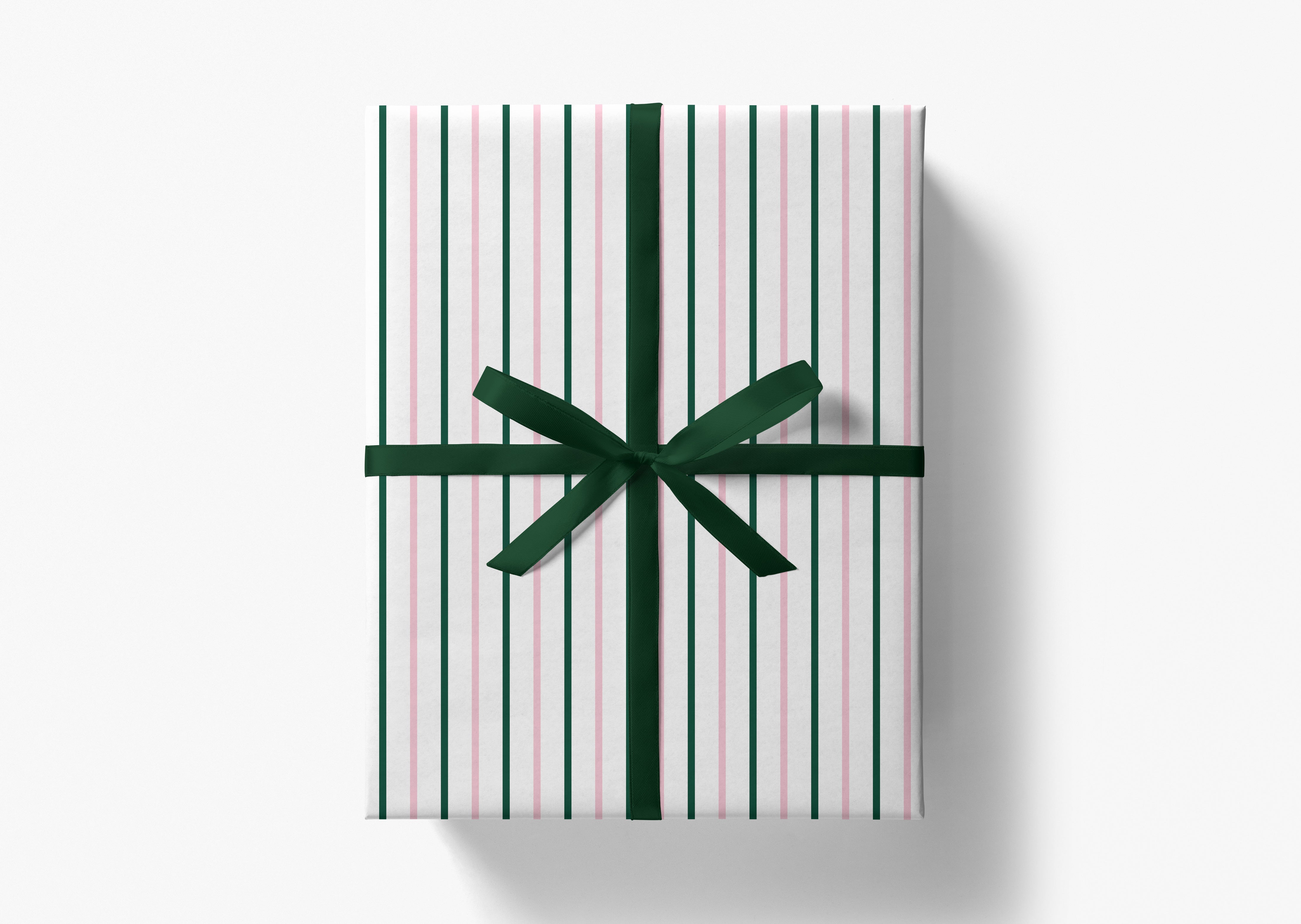 A gift box wrapped in a striped paper with a green ribbon bow tied around it.