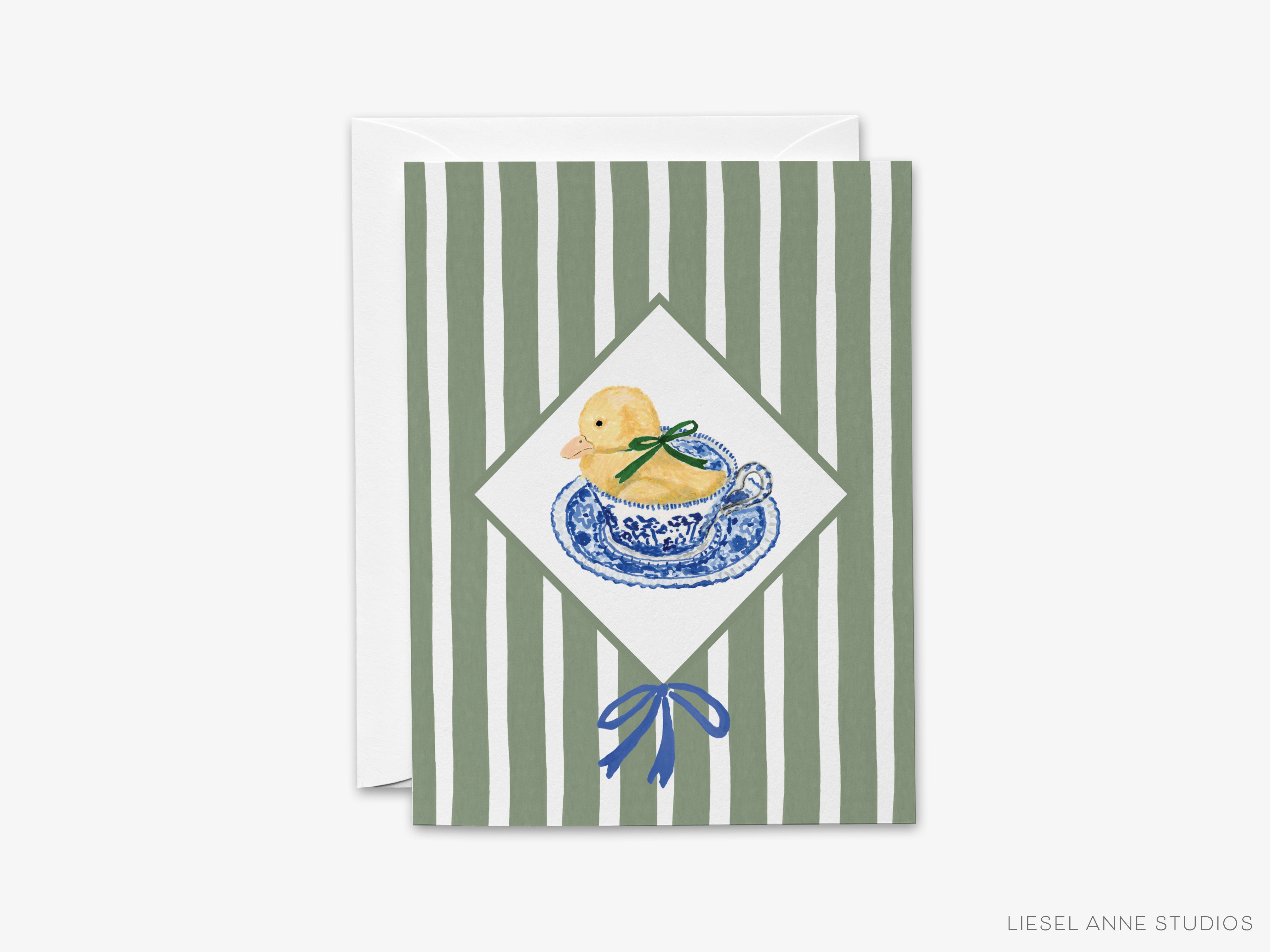 A greeting card with a yellow duck sitting on a blue and white plate, surrounded by green and white striped patterns.