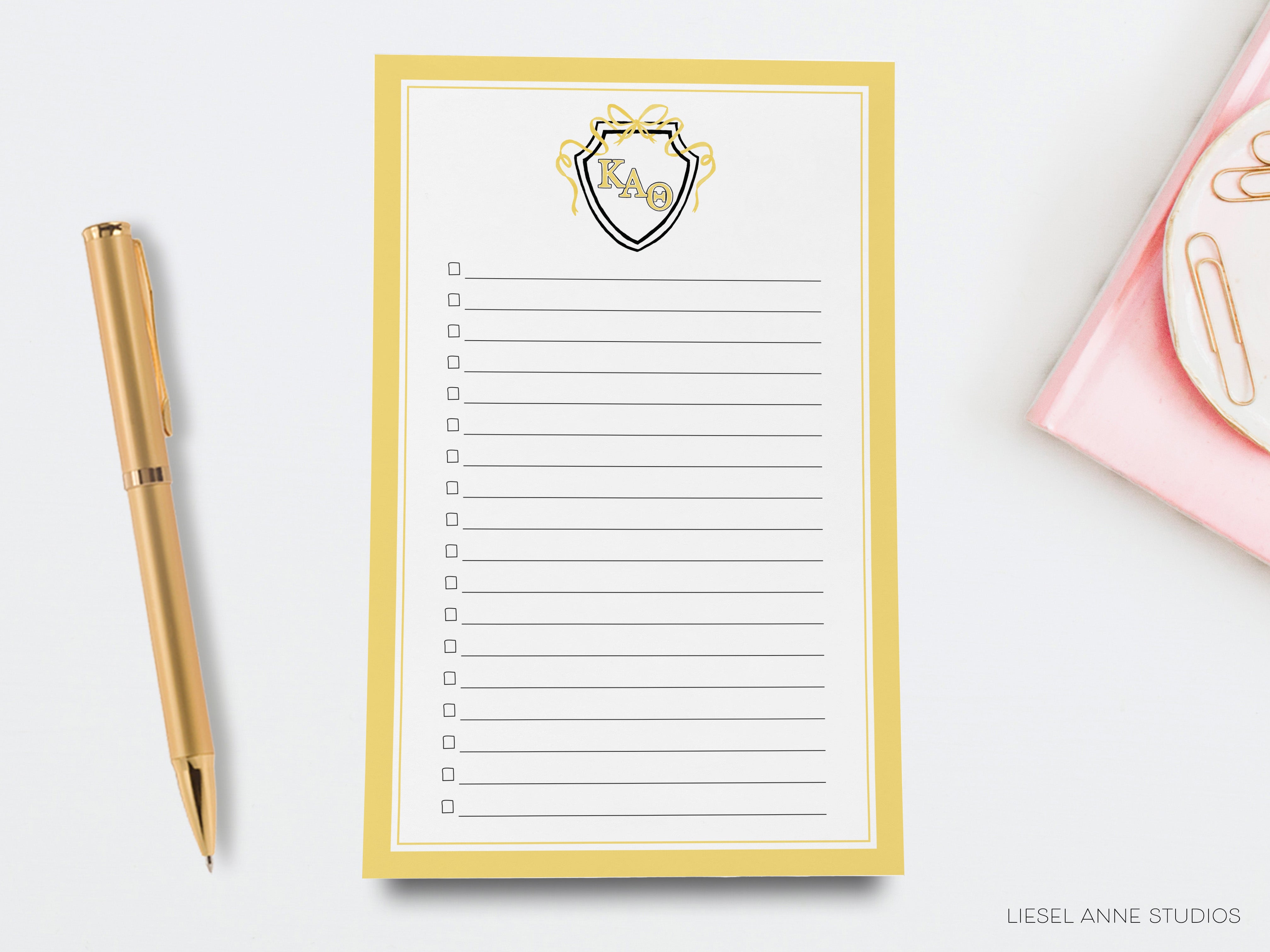 a notepad with a pen next to it on a desk