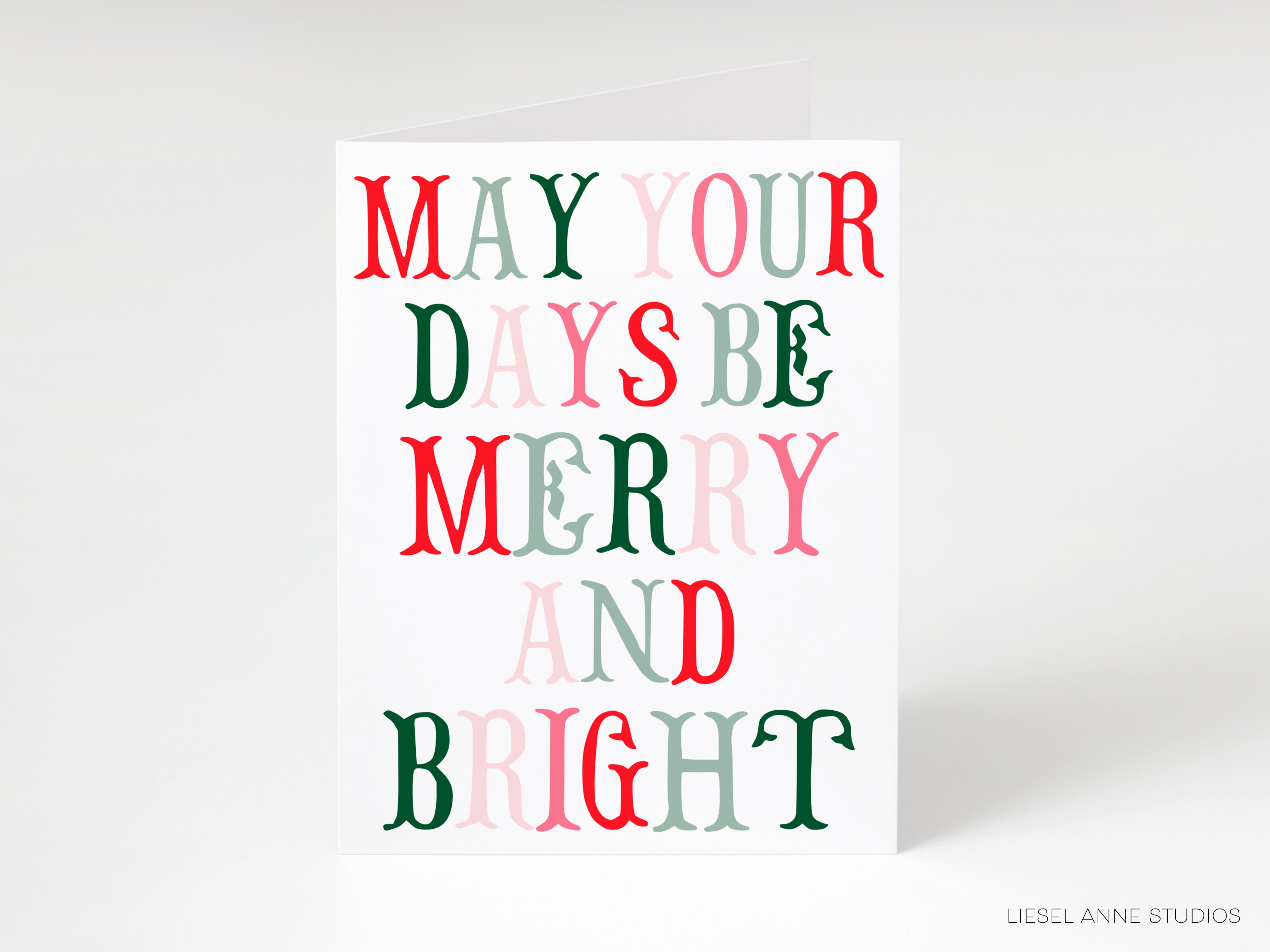 A greeting card with the text "MAY YOUR DAYS BE MERRY AND BRIGHT" in a colorful, stylized font.