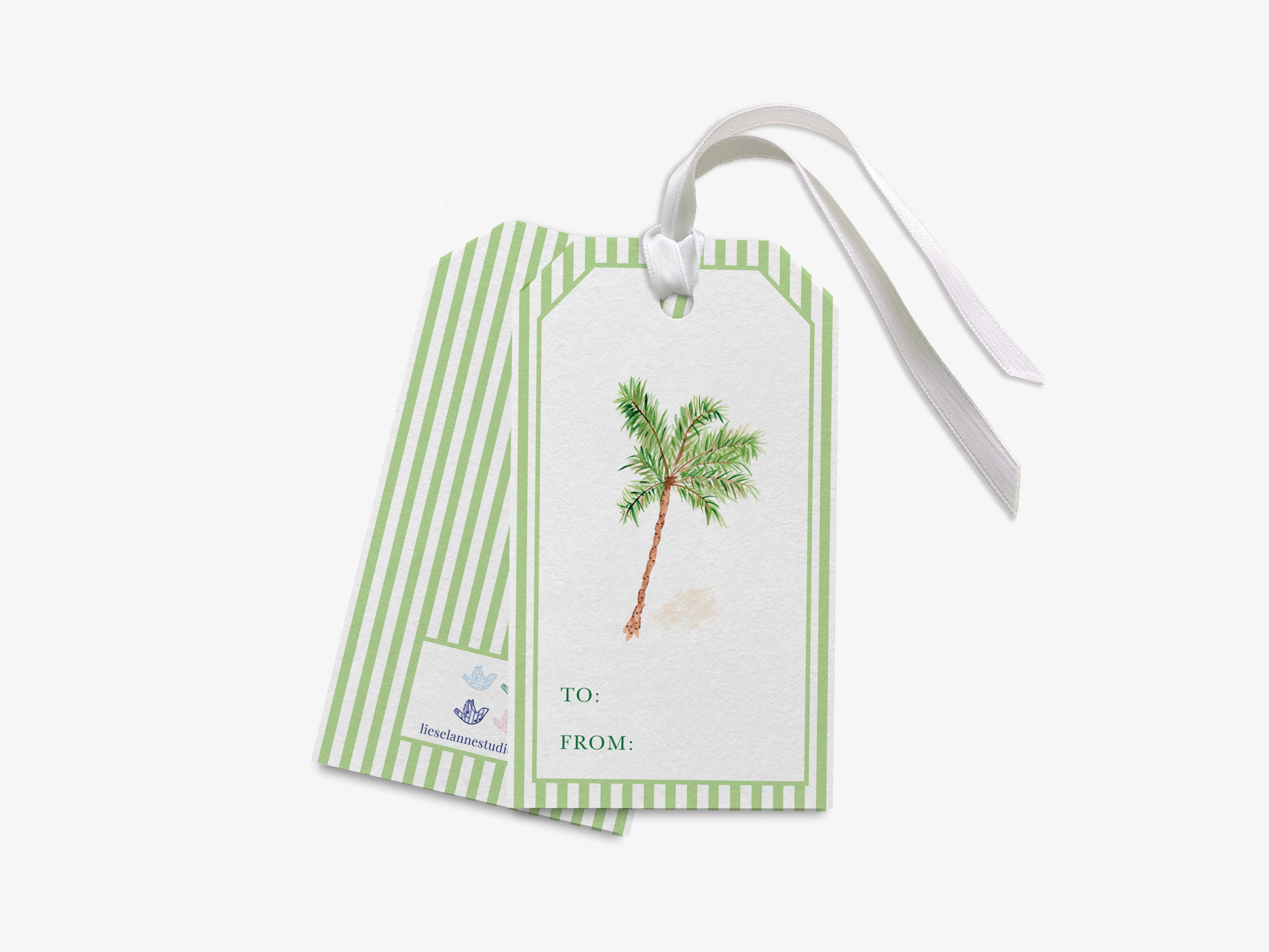 a green and white striped gift tag with a palm tree illustration on it.
