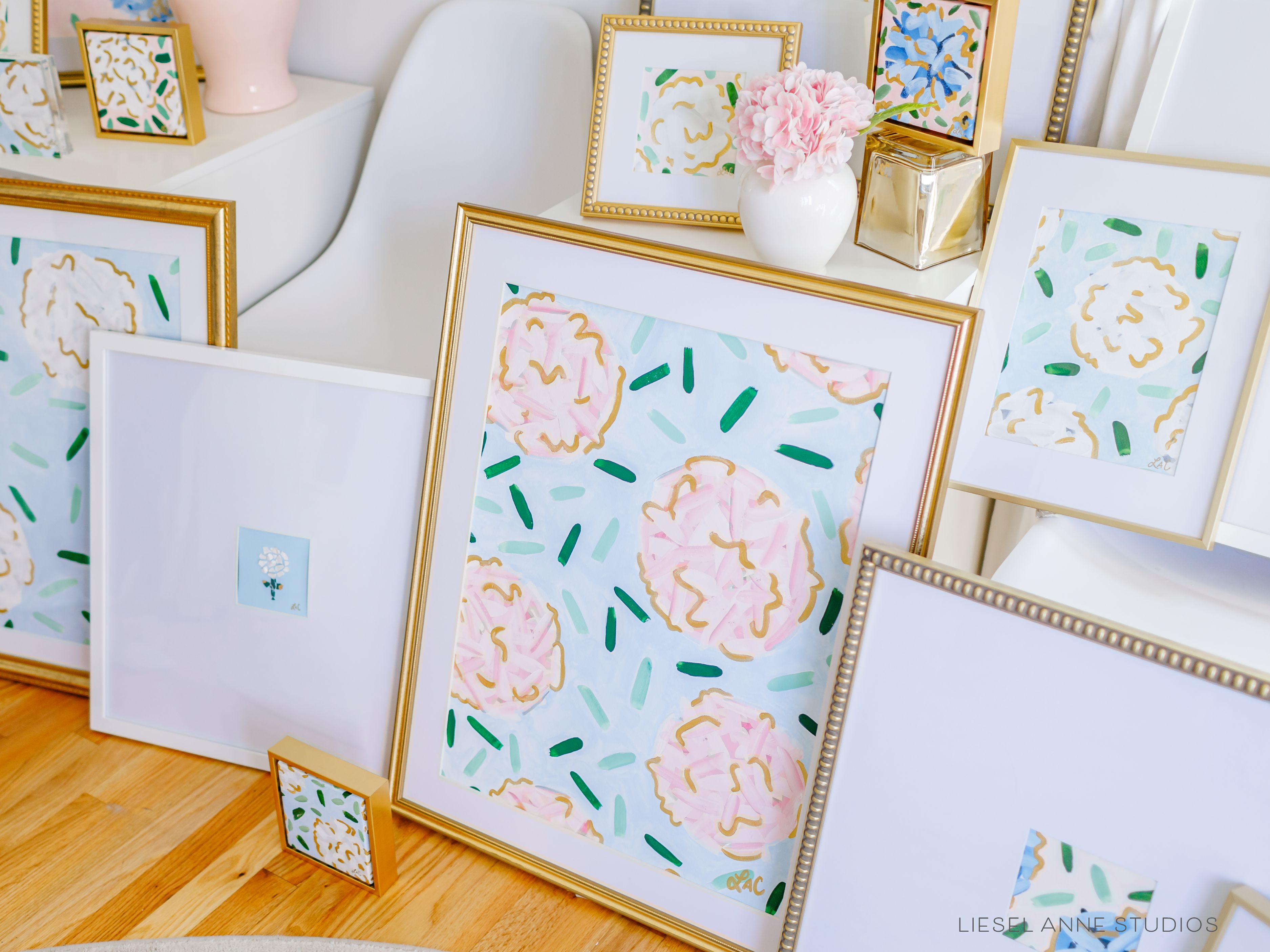 Golden Hydrangea | Blue & Pink II-Original artwork measures 18" x 24" | Hand-Painted with gouache on cold press watercolor paper | Matted and framed in gold wood frame sized 22" x 28" | UV shielding acrylic glass | Hanging hardware included | Features our signature Golden Hydrangea design with a light blue base, pink hydrangeas and shimmery gold accents | Initialed in gold by the Liesel Anne (the artist) on the front and signed and dated on the back.-The Singing Little Bird