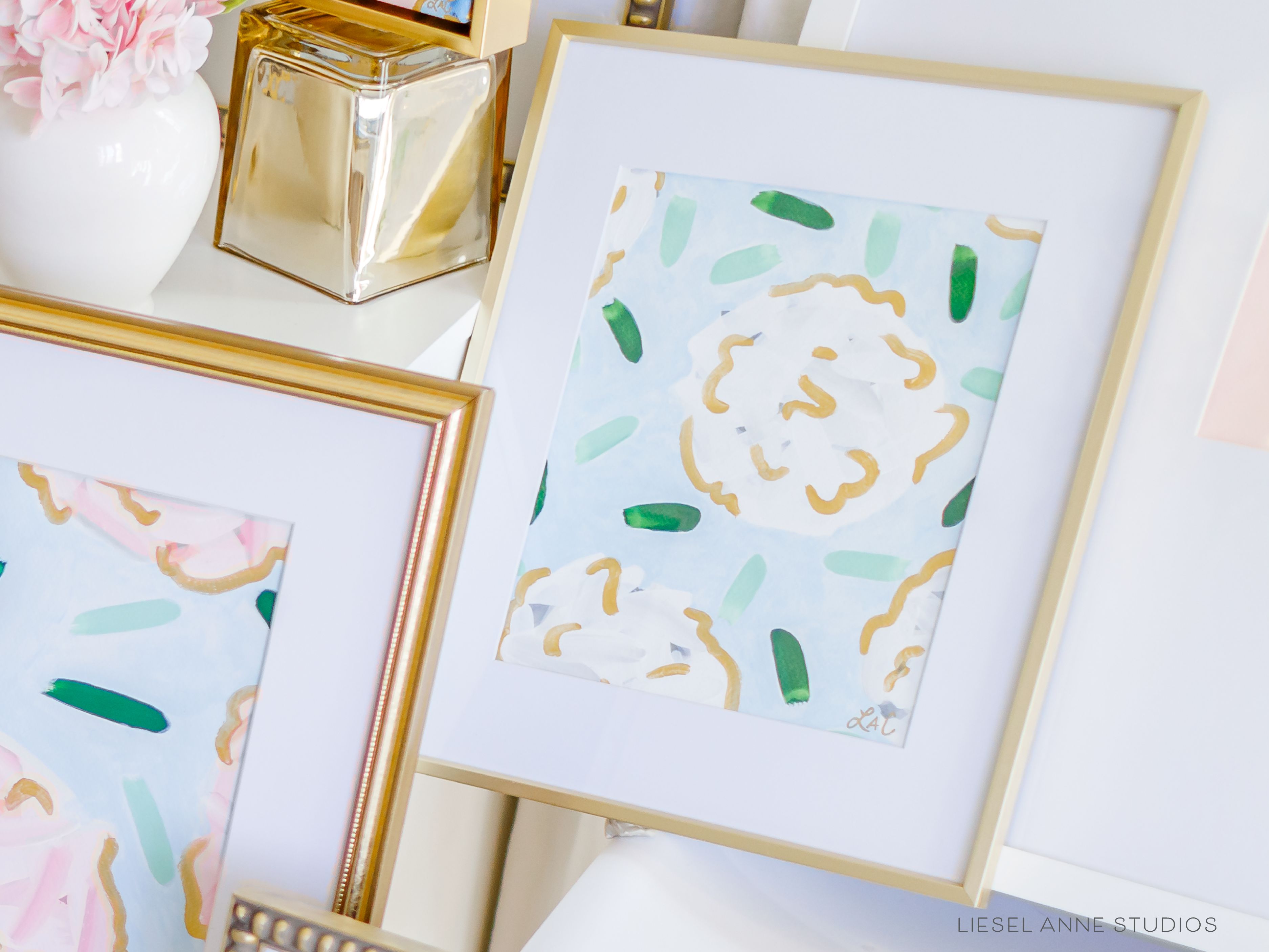 Golden Hydrangea | Blue & White X-Original artwork measures 8"x10" | Hand-Painted with gouache on cold press watercolor paper | Matted and framed in gold wood frame sized 11"x14" | UV shielding acrylic glass | Hanging hardware included | Features our signature Golden Hydrangea design with a light blue base, white hydrangeas and shimmery gold accents | Initialed in gold by the Liesel Anne (the artist) on the front and signed and dated on the back.-The Singing Little Bird