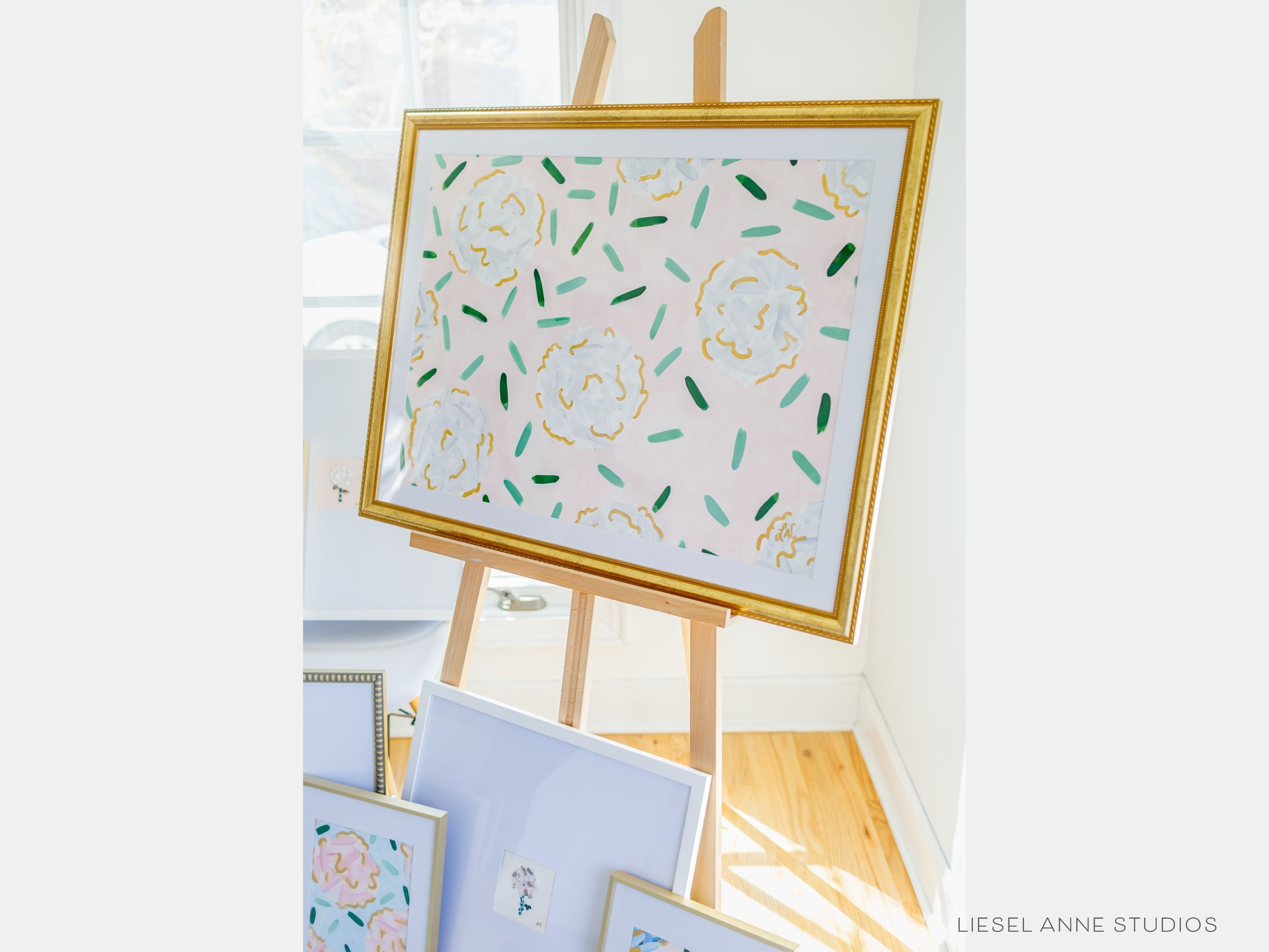 Golden Hydrangea | Blush & White IV-Original artwork measures 22"x30"" | Hand-Painted with gouache on cold press watercolor paper | Matted and framed in gold wood frame sized 27 1/4" x 35 1/4" | UV shielding acrylic glass | Hanging hardware included | Features our signature Golden Hydrangea design with a pale pink base, white hydrangeas and shimmery gold accents | Initialed in gold by the Liesel Anne (the artist) on the front and signed and dated on the back.-The Singing Little Bird