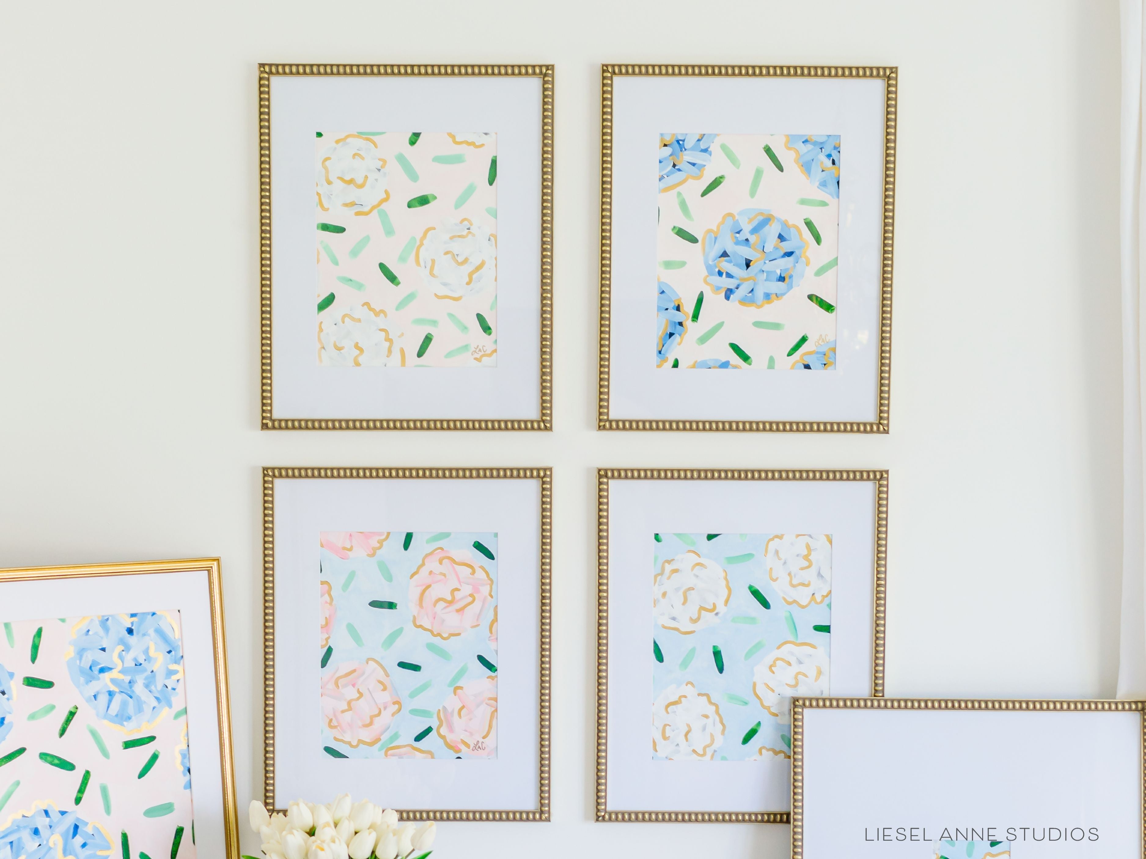 Golden Hydrangea | Blush & White VI-Original artwork measures 11"x14" | Hand-Painted with gouache on cold press watercolor paper | Matted and framed in gold wood frame sized 16"x20" | Glare-resistant glass | Hanging hardware included | Features our signature Golden Hydrangea design with a pale pink base, white hydrangeas and shimmery gold accents | Initialed in gold by the Liesel Anne (the artist) on the front and signed and dated on the back.-The Singing Little Bird