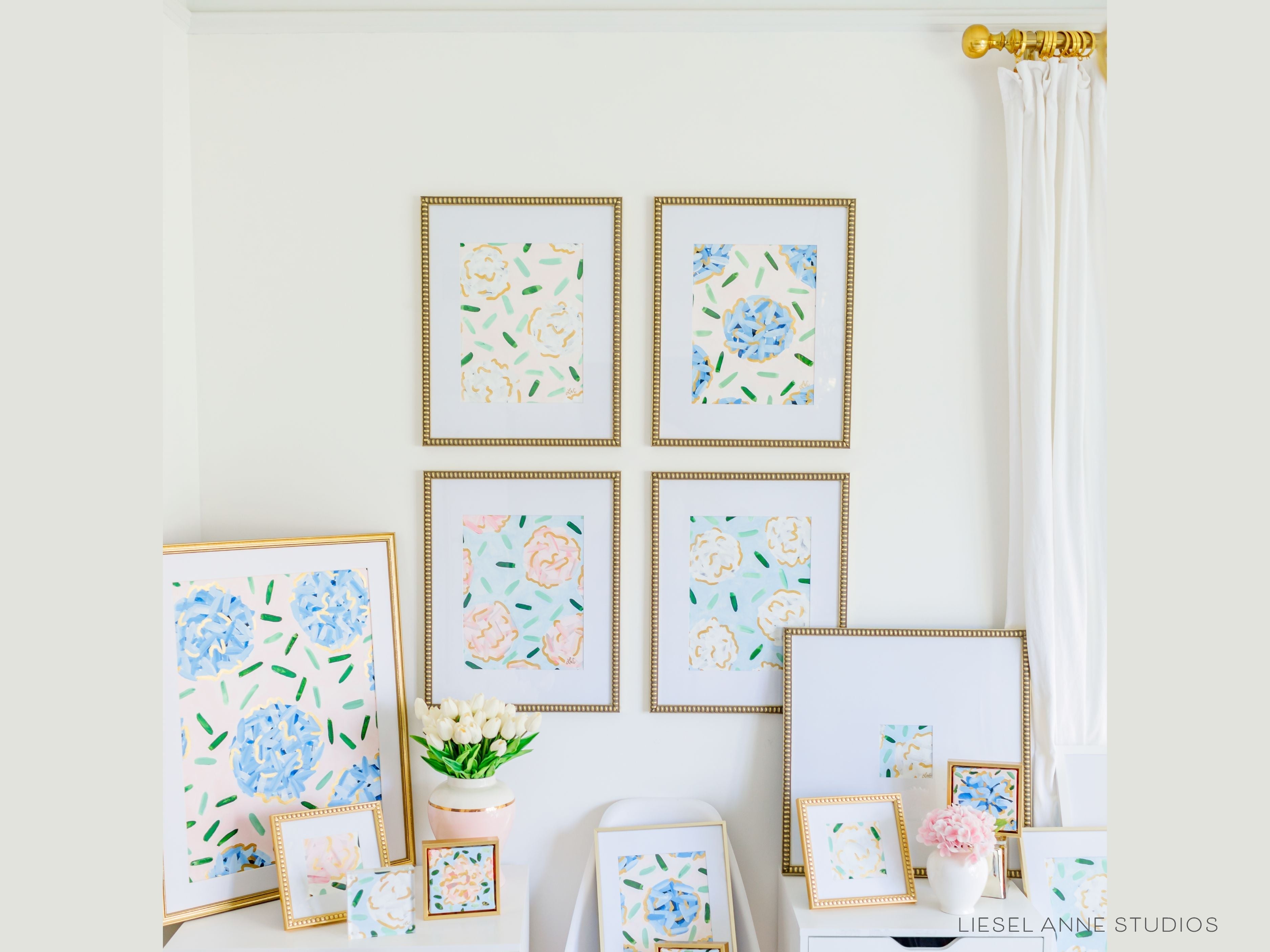 Golden Hydrangea | Blush & White VI-Original artwork measures 11"x14" | Hand-Painted with gouache on cold press watercolor paper | Matted and framed in gold wood frame sized 16"x20" | Glare-resistant glass | Hanging hardware included | Features our signature Golden Hydrangea design with a pale pink base, white hydrangeas and shimmery gold accents | Initialed in gold by the Liesel Anne (the artist) on the front and signed and dated on the back.-The Singing Little Bird