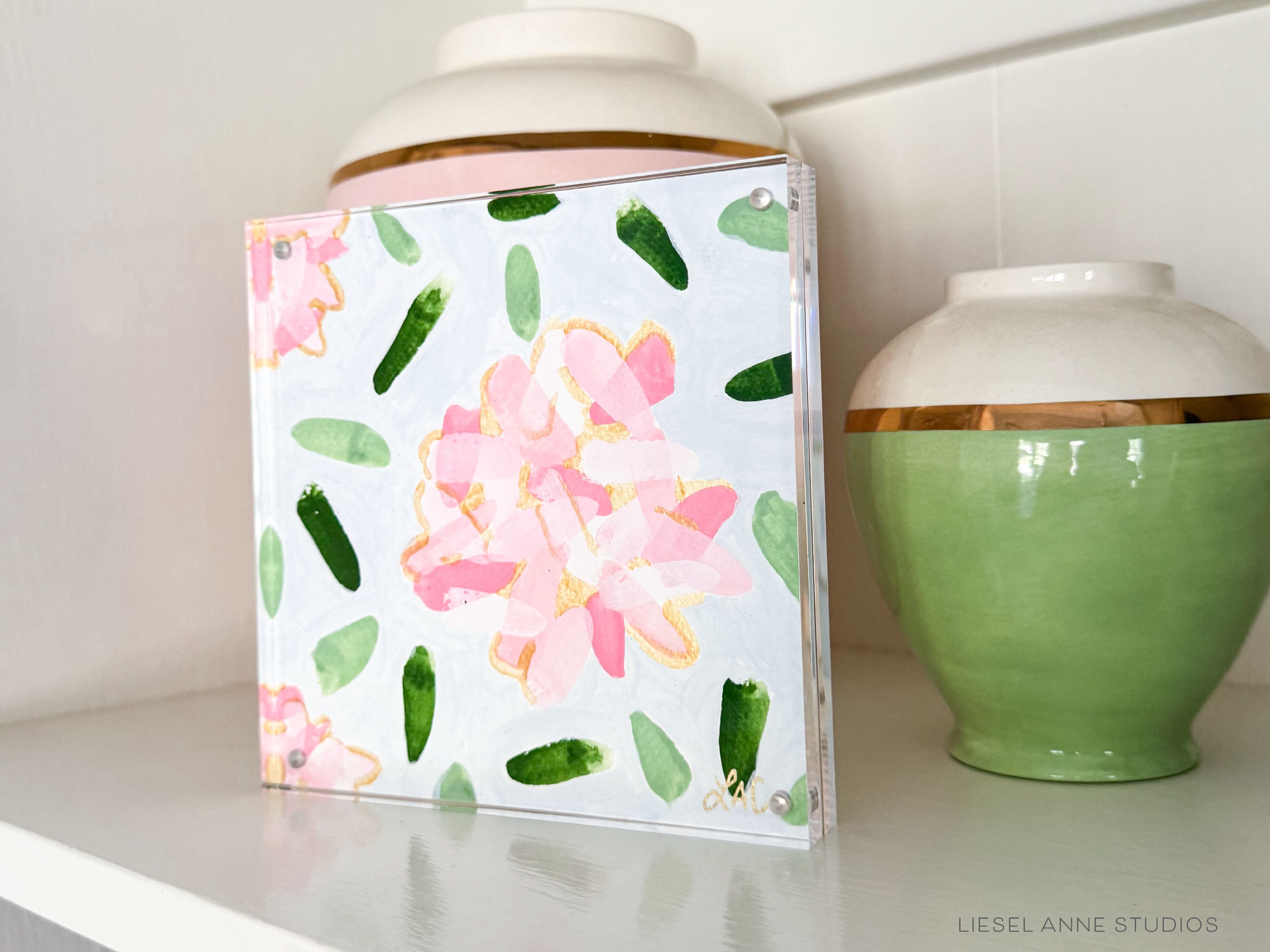 Golden Hydrangea Mini | Blue & Pink 04-Original artwork measures 6"x6" | Hand-Painted with gouache on cold press watercolor paper | Framed in clear acrylic magnetic block frame | Features our signature Golden Hydrangea design with a light blue base, pink hydrangeas and shimmery gold accents | Initialed in gold by the Liesel Anne (the artist) on the front and signed and dated on the back-The Singing Little Bird