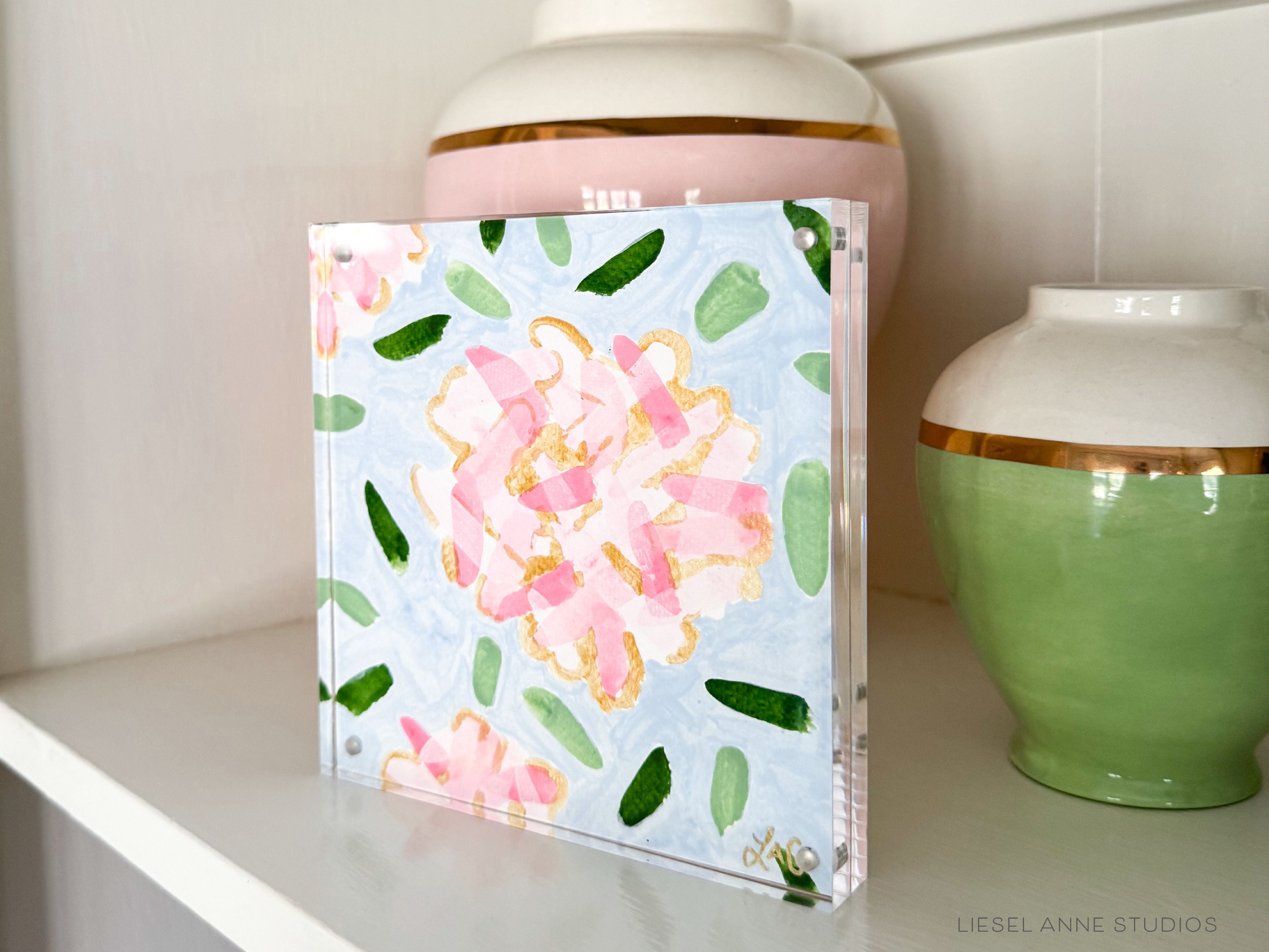 Golden Hydrangea Mini | Blue & Pink 07-Original artwork measures 6"x6" | Hand-Painted with gouache on cold press watercolor paper | Framed in clear acrylic magnetic block frame | Features our signature Golden Hydrangea design with a light blue base, pink hydrangeas and shimmery gold accents | Initialed in gold by the Liesel Anne (the artist) on the front and signed and dated on the back-The Singing Little Bird