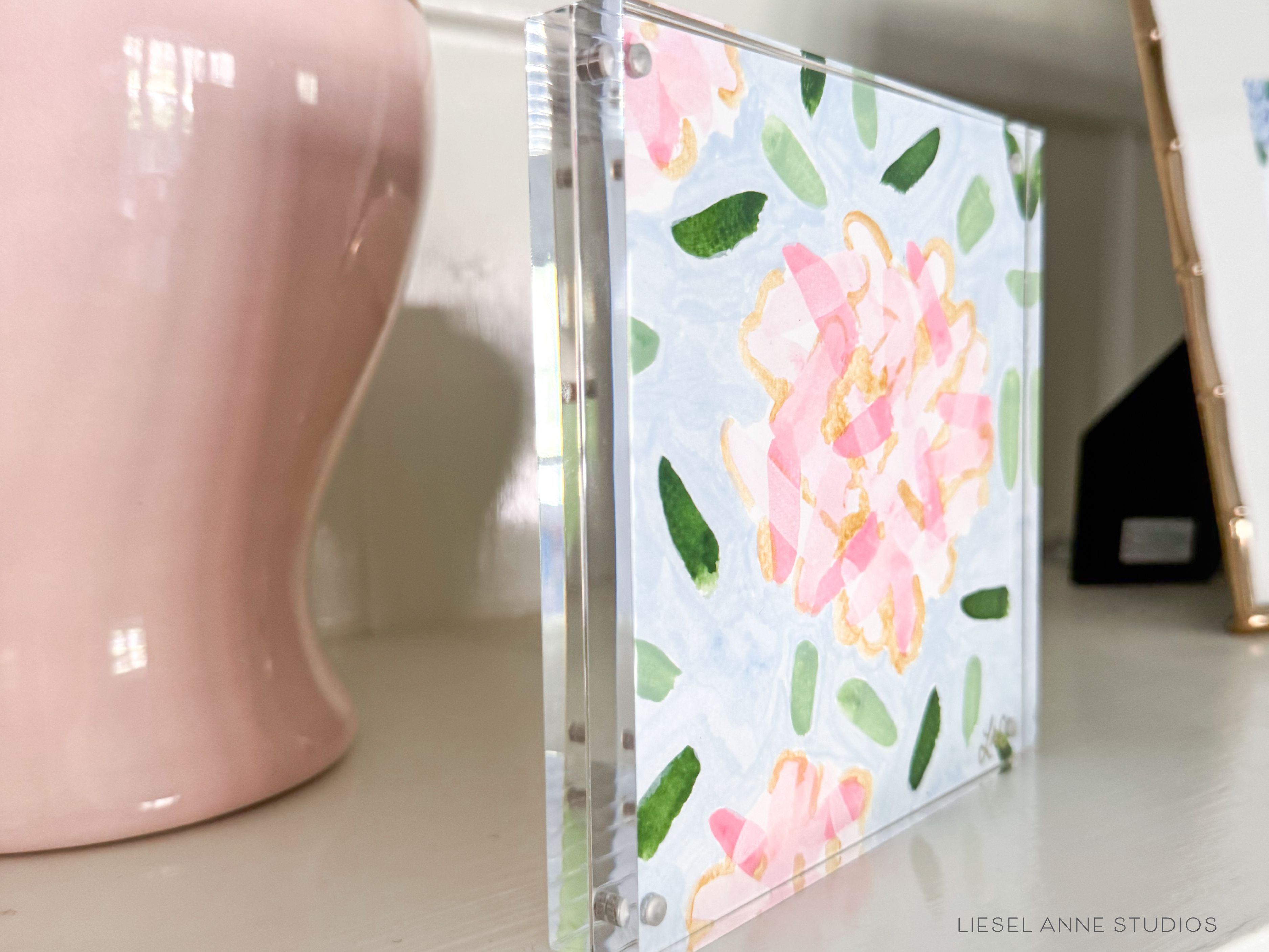Golden Hydrangea Mini | Blue & Pink 07-Original artwork measures 6"x6" | Hand-Painted with gouache on cold press watercolor paper | Framed in clear acrylic magnetic block frame | Features our signature Golden Hydrangea design with a light blue base, pink hydrangeas and shimmery gold accents | Initialed in gold by the Liesel Anne (the artist) on the front and signed and dated on the back-The Singing Little Bird