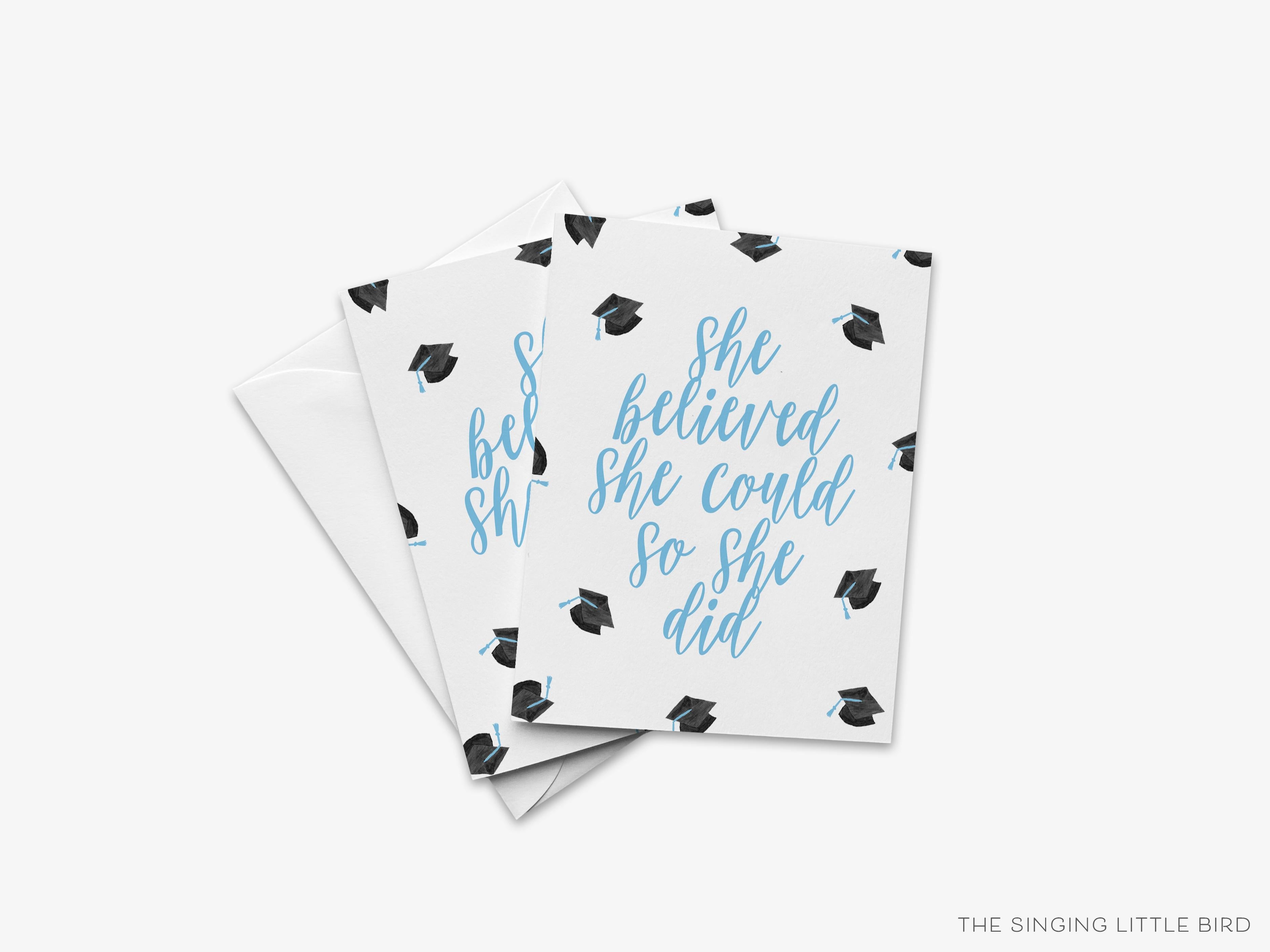 She Believed She Could So She Did Graduation Card - Blue-These folded greeting cards are 4.25x5.5 and feature our hand-painted graduation caps, printed in the USA on 100lb textured stock. They come with a White envelope and make a great congratulations card for the female graduate in your life.-The Singing Little Bird