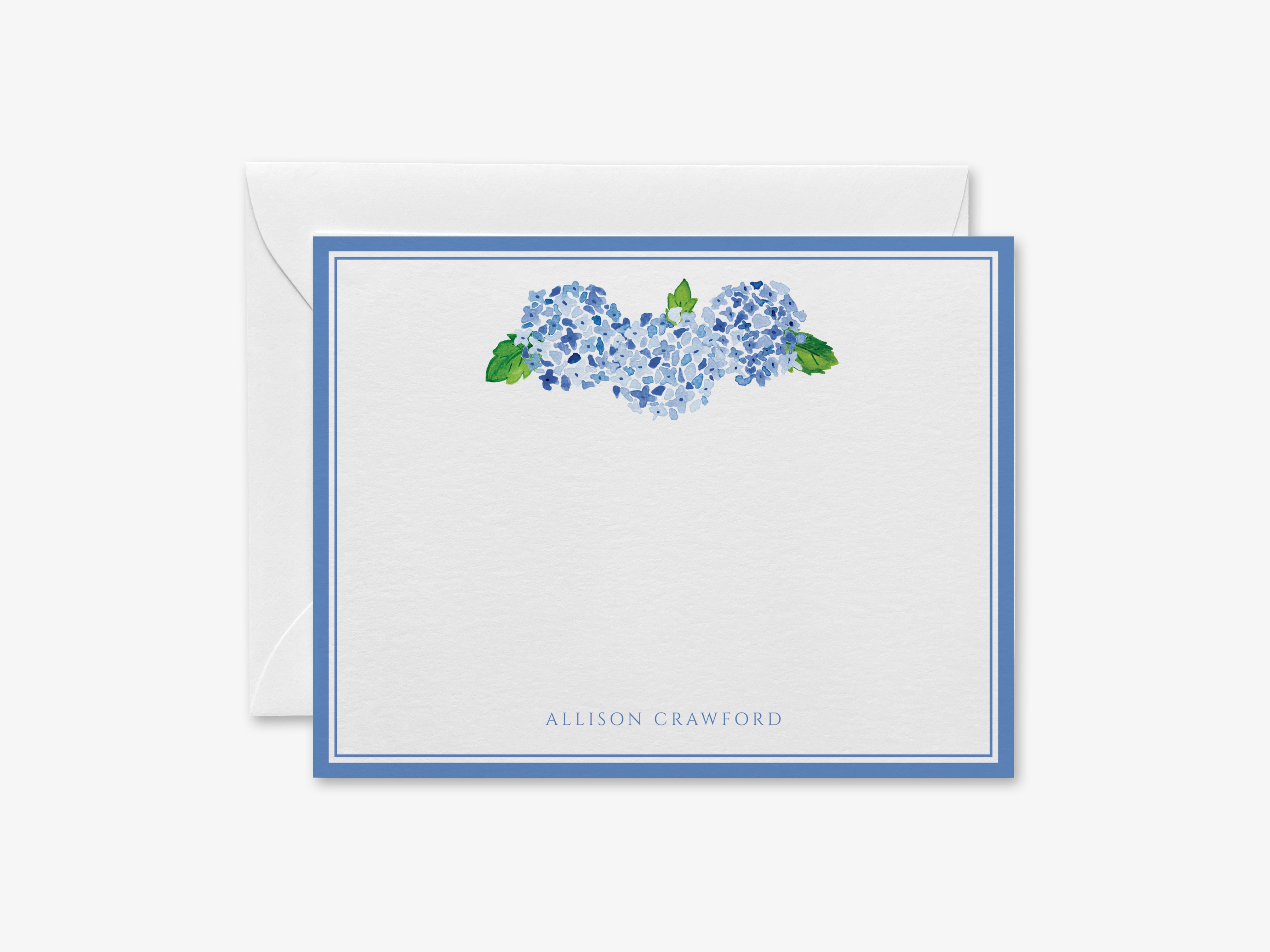 A white card with a blue border, featuring a watercolor illustration of blue hydrangeas and green leaves.
