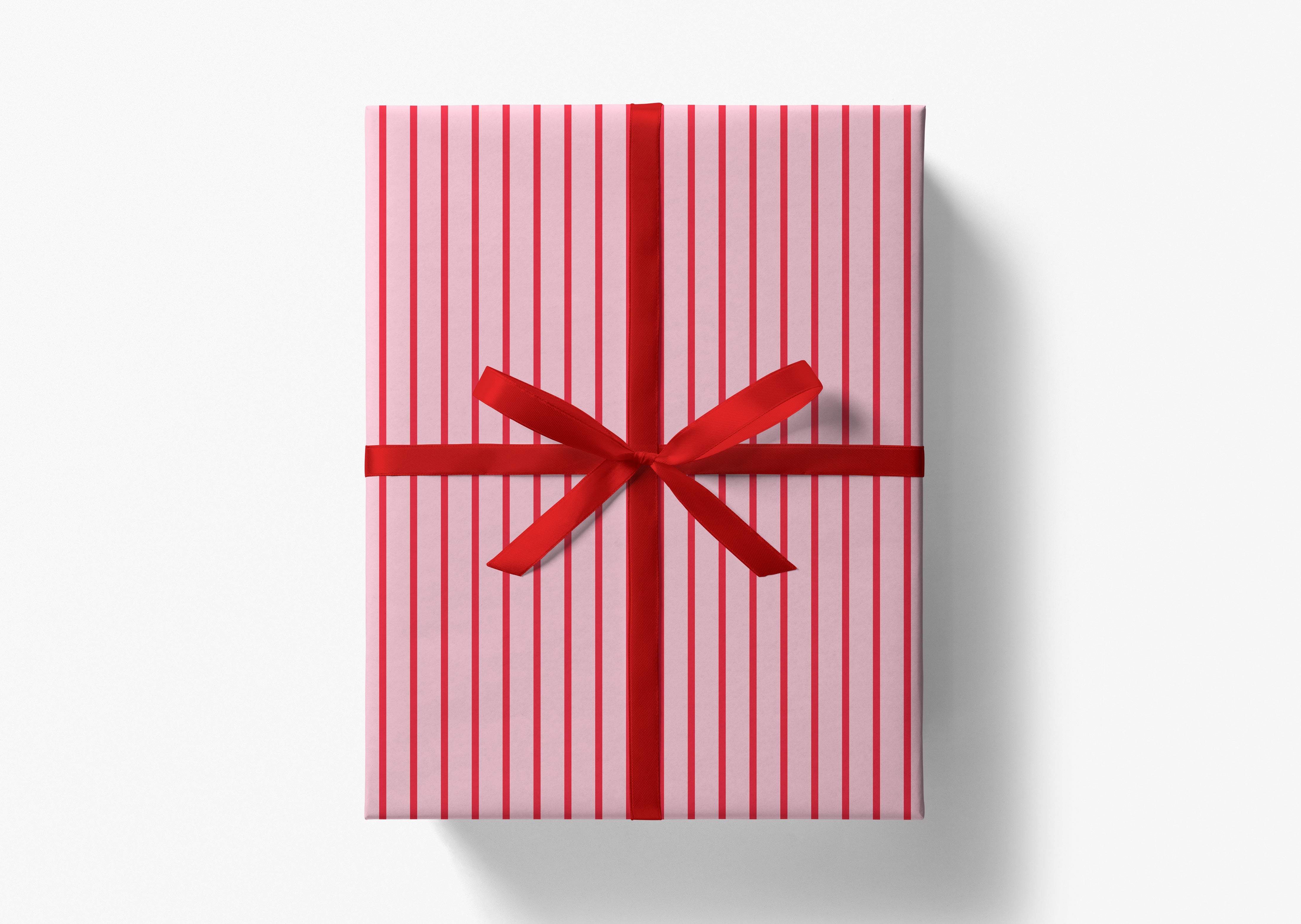 A red and white striped gift box with a red ribbon bow tied around it.
