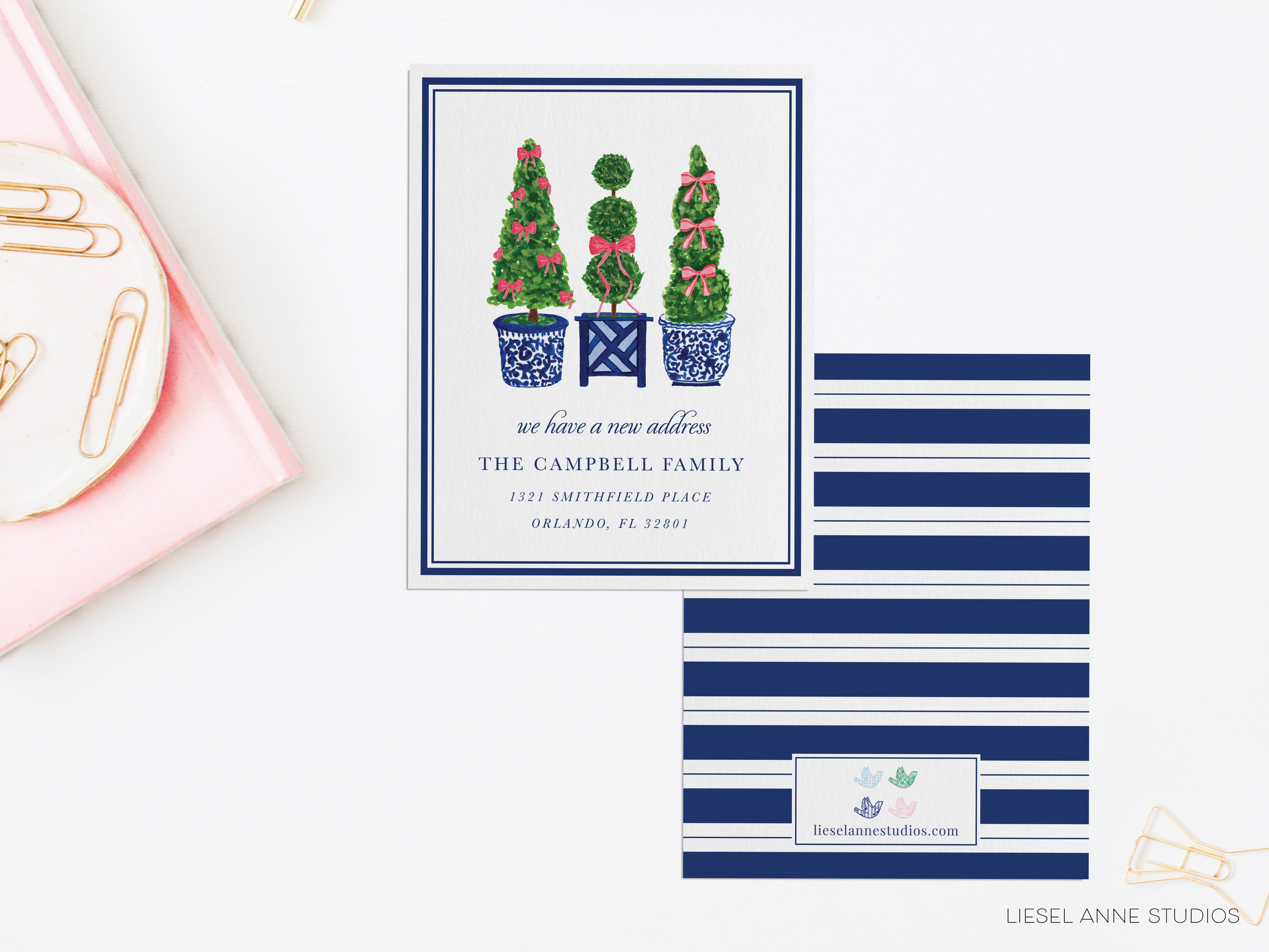 The image is a collage of three different images. The top image features a white card with a blue border and illustrations of three topiary trees. The middle image is a pink background with a white text box containing the text "we have a new address THE CAMPBELL FAMILY 1531 SMITHFIELD PARK ORLEANS, FL 33808". The bottom image is a blue and white striped background with a white text box containing the text "lesenanne Studios www.lesenanne studios".