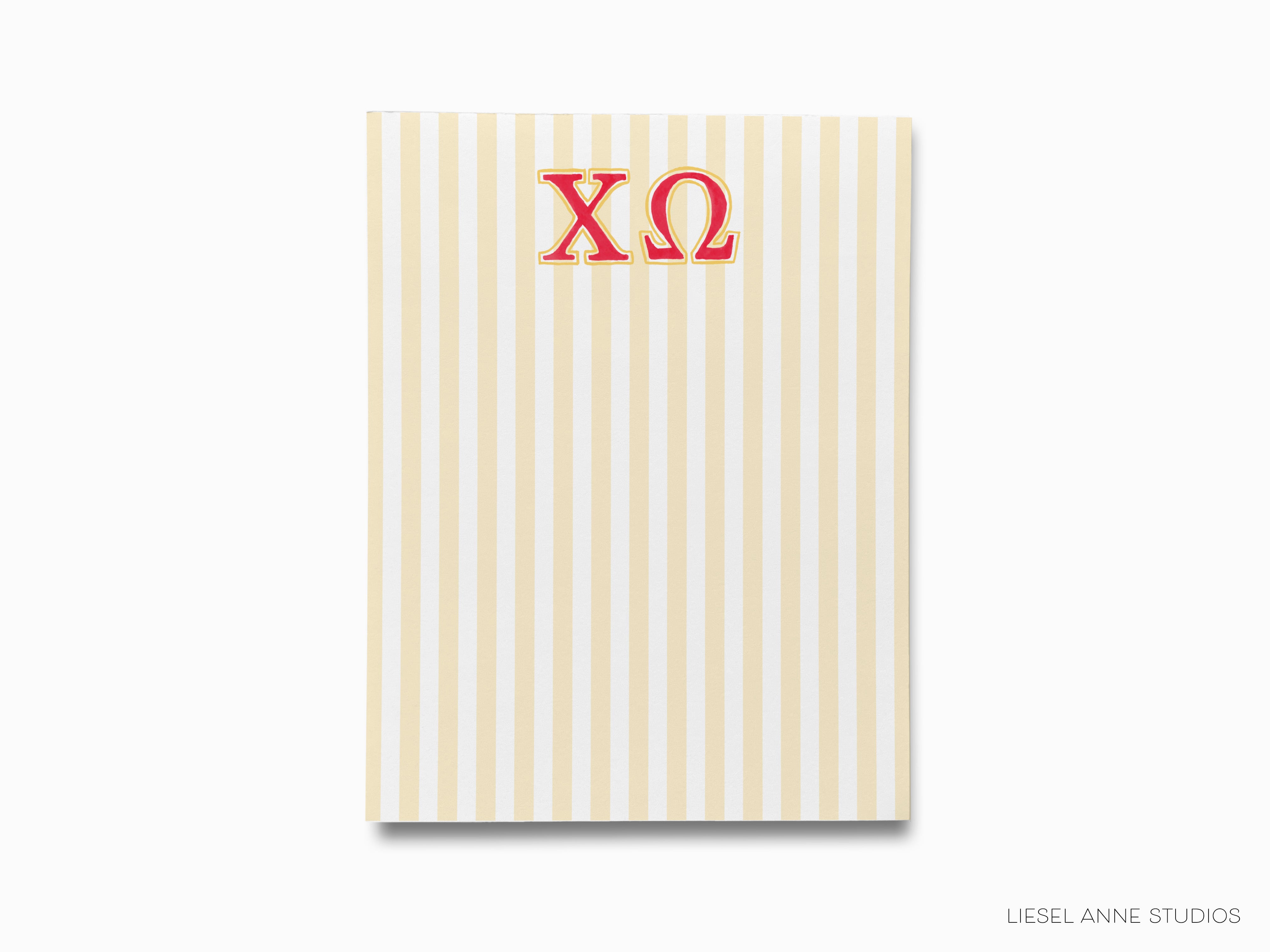 a striped notebook with the letter xo on it