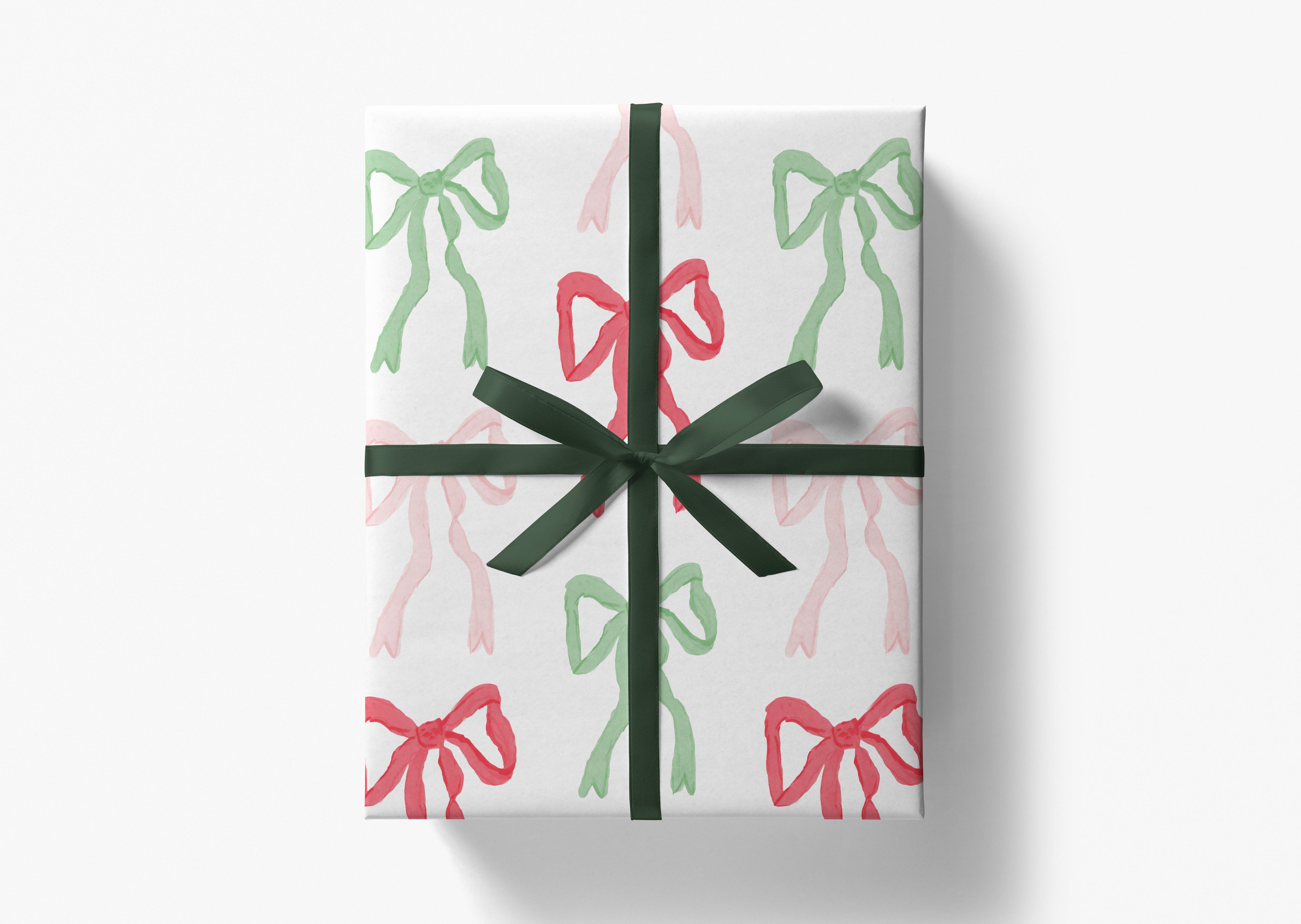 A gift box with a green ribbon and bows in shades of pink and green.