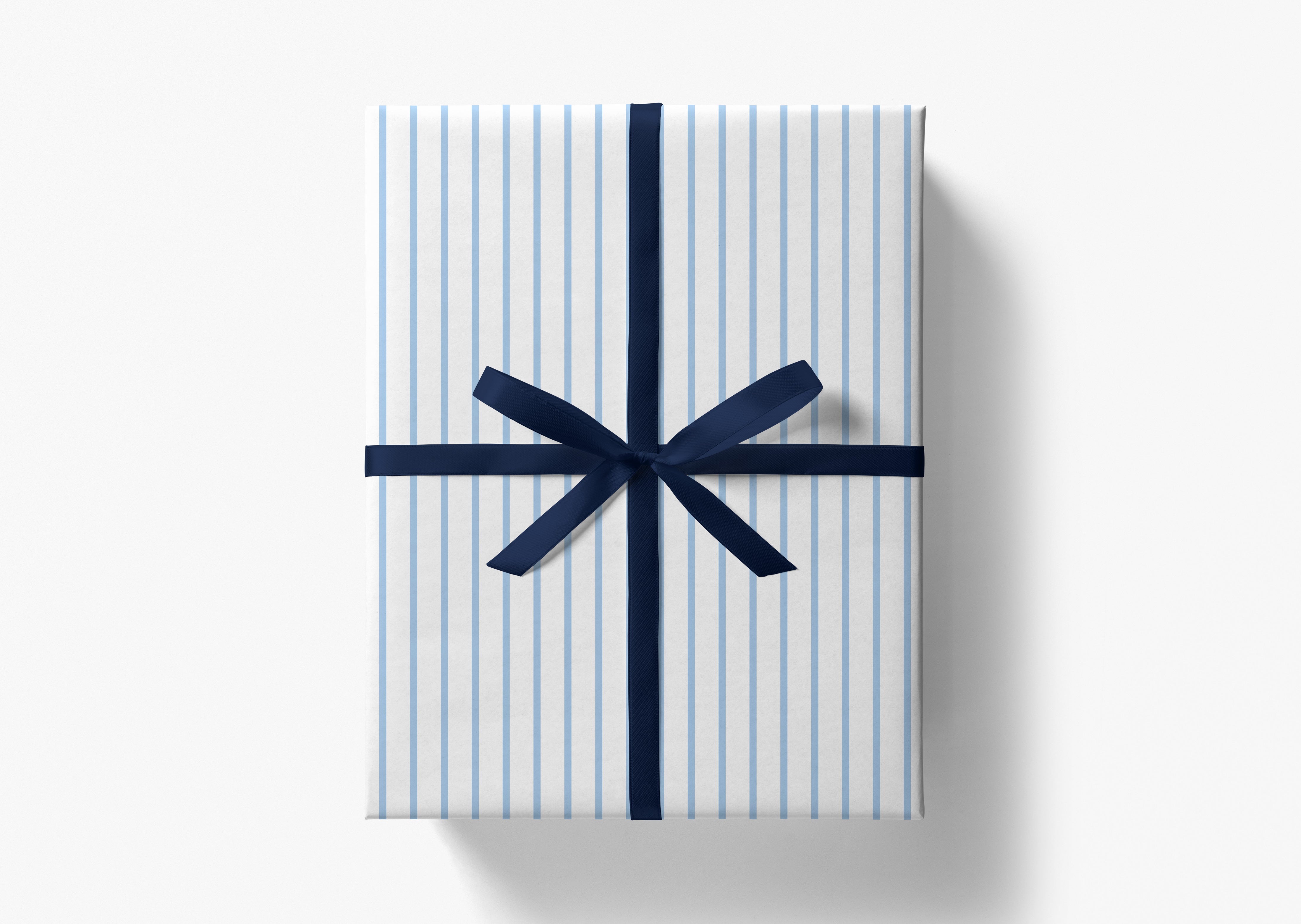A gift box wrapped in blue and white striped paper with a navy blue ribbon bow tied around it.