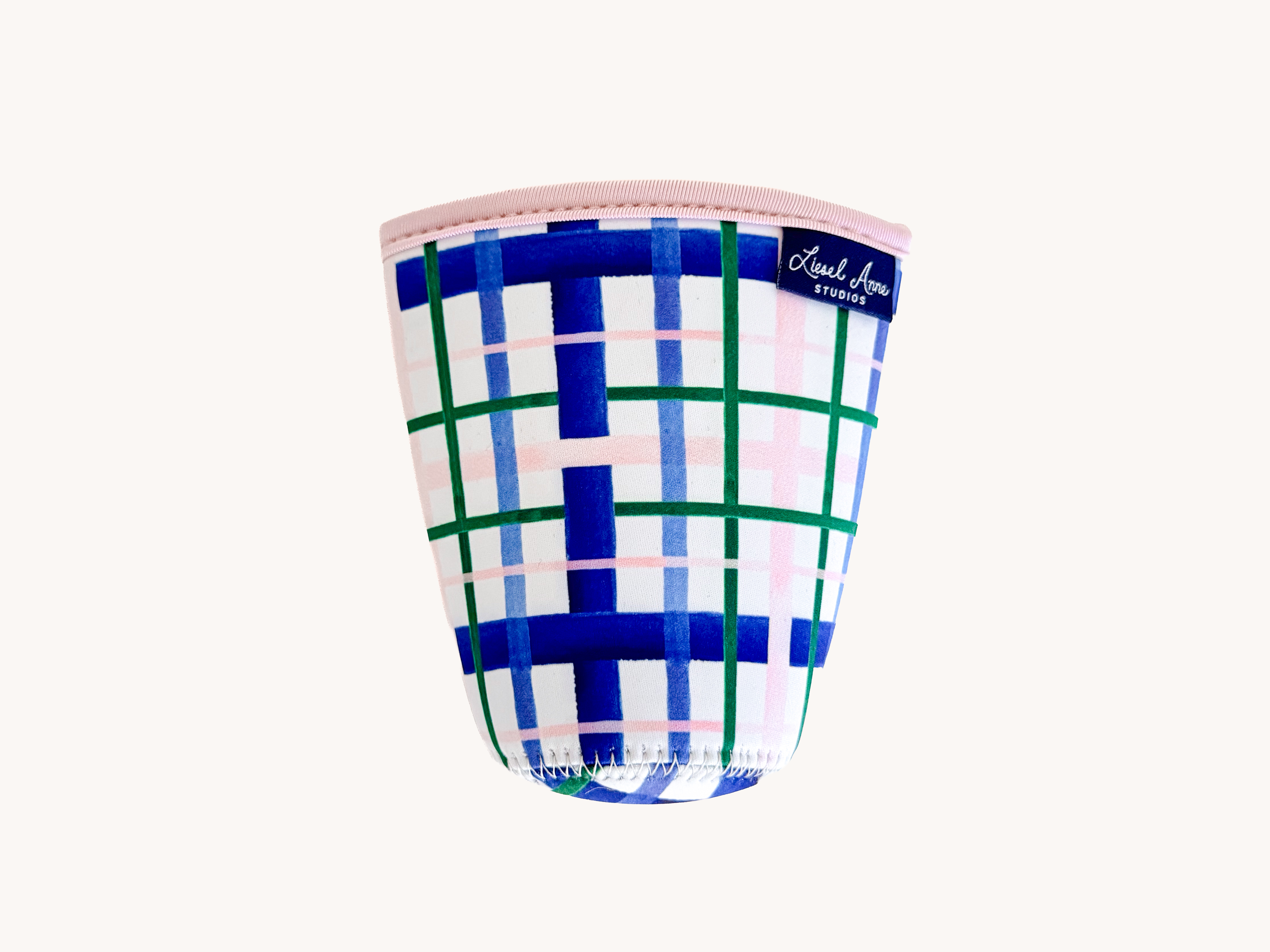 A colorful cup with a plaid pattern in shades of blue, pink, and green.