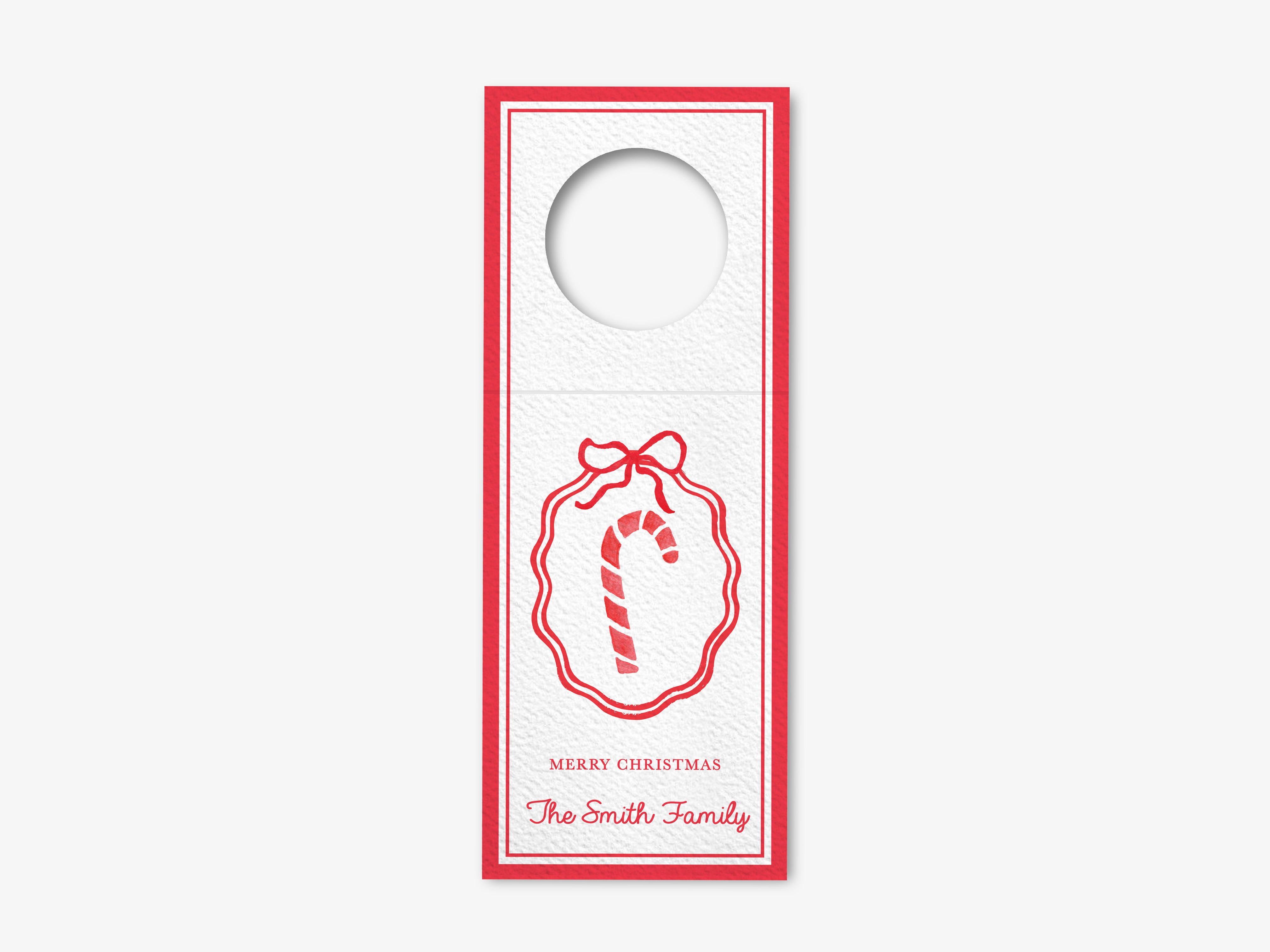 A white wine bottle tag with a red border and a red ribbon wreath design.