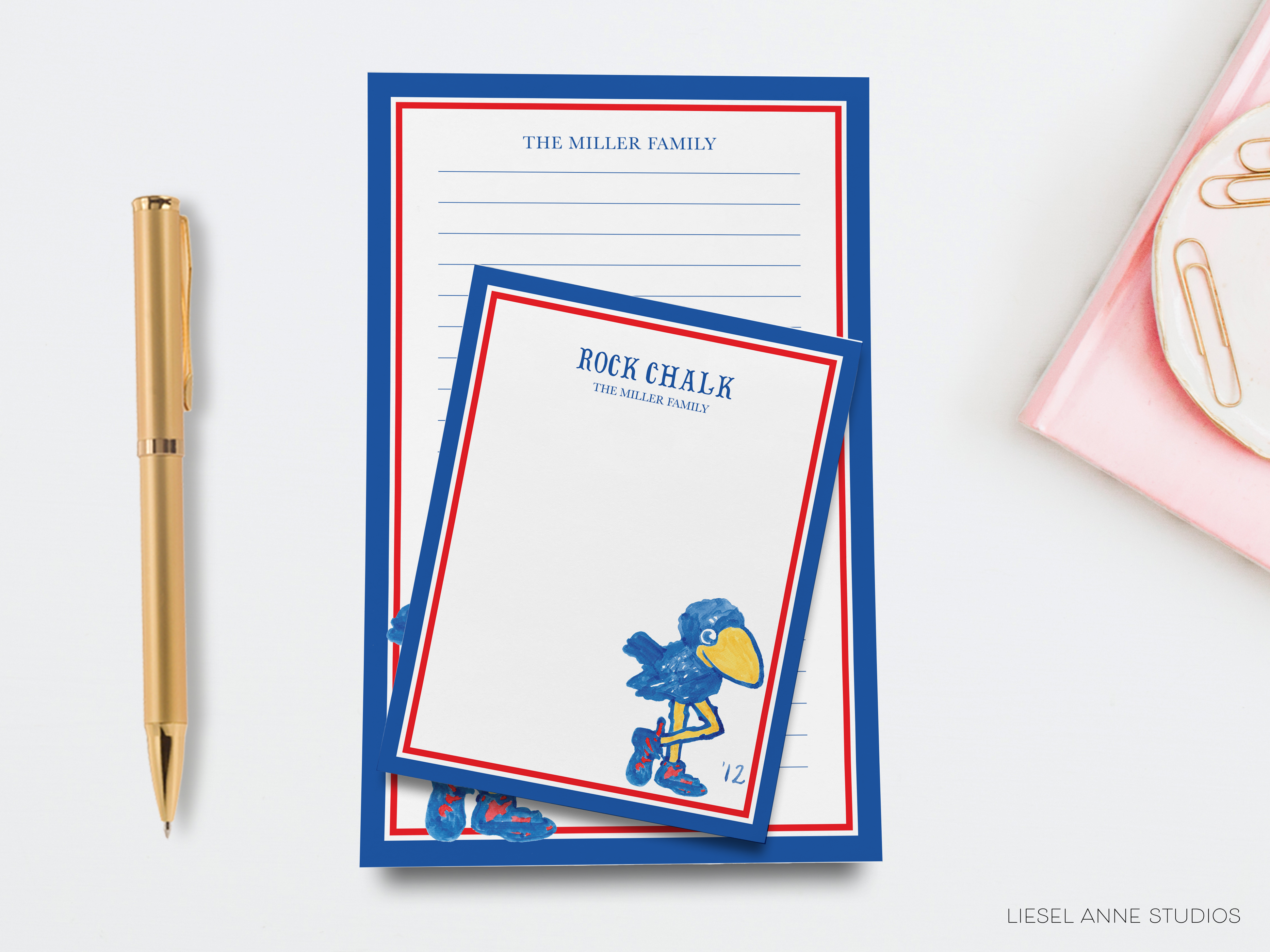a set of colorful post-it notes and a gold pen on a white background.