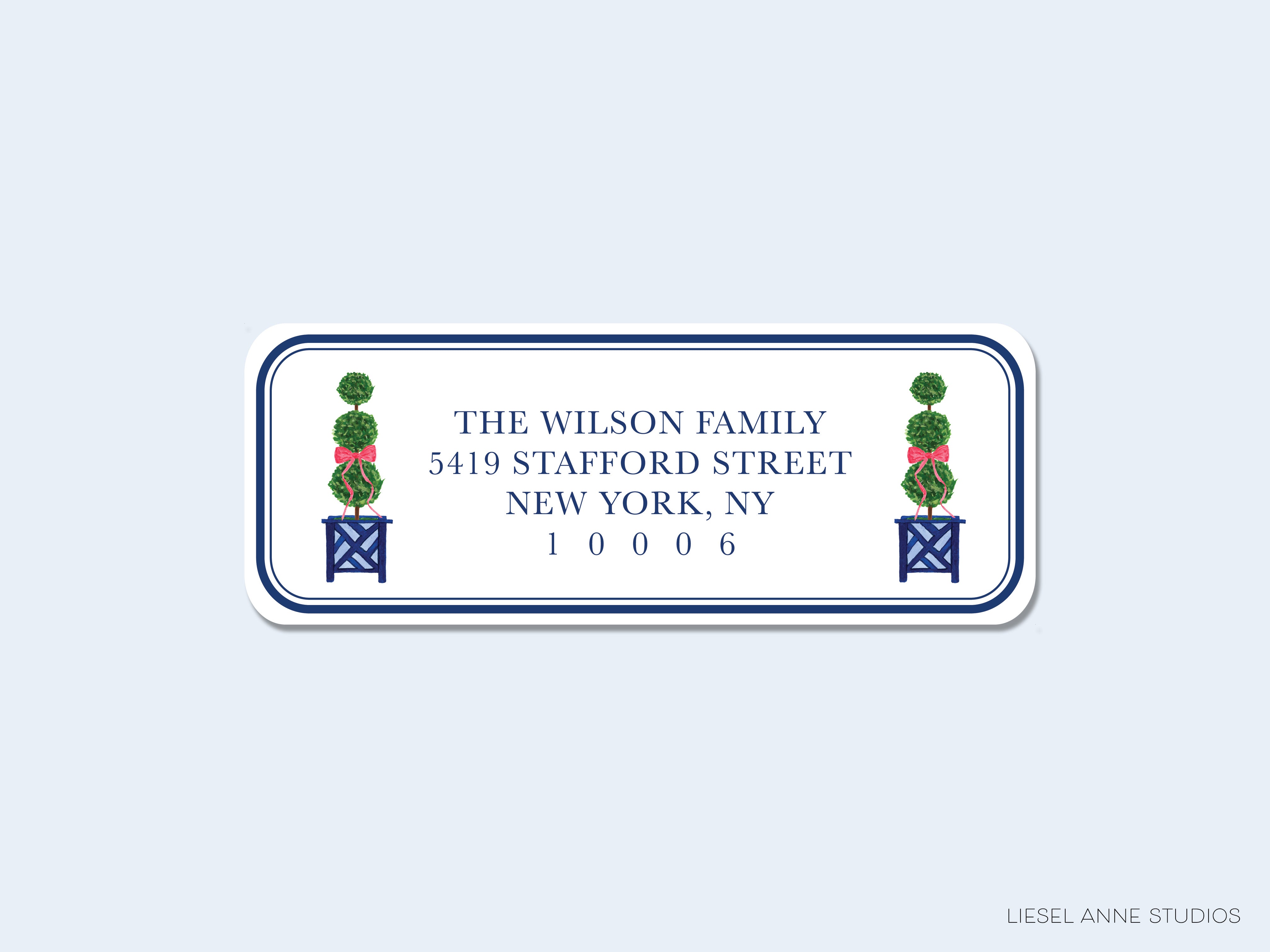 The image is a rectangular address label with the address "5419 STAFFORD STREET NEW YORK, NY 10006" printed on it. There are two green topiary trees on either side of the address label.