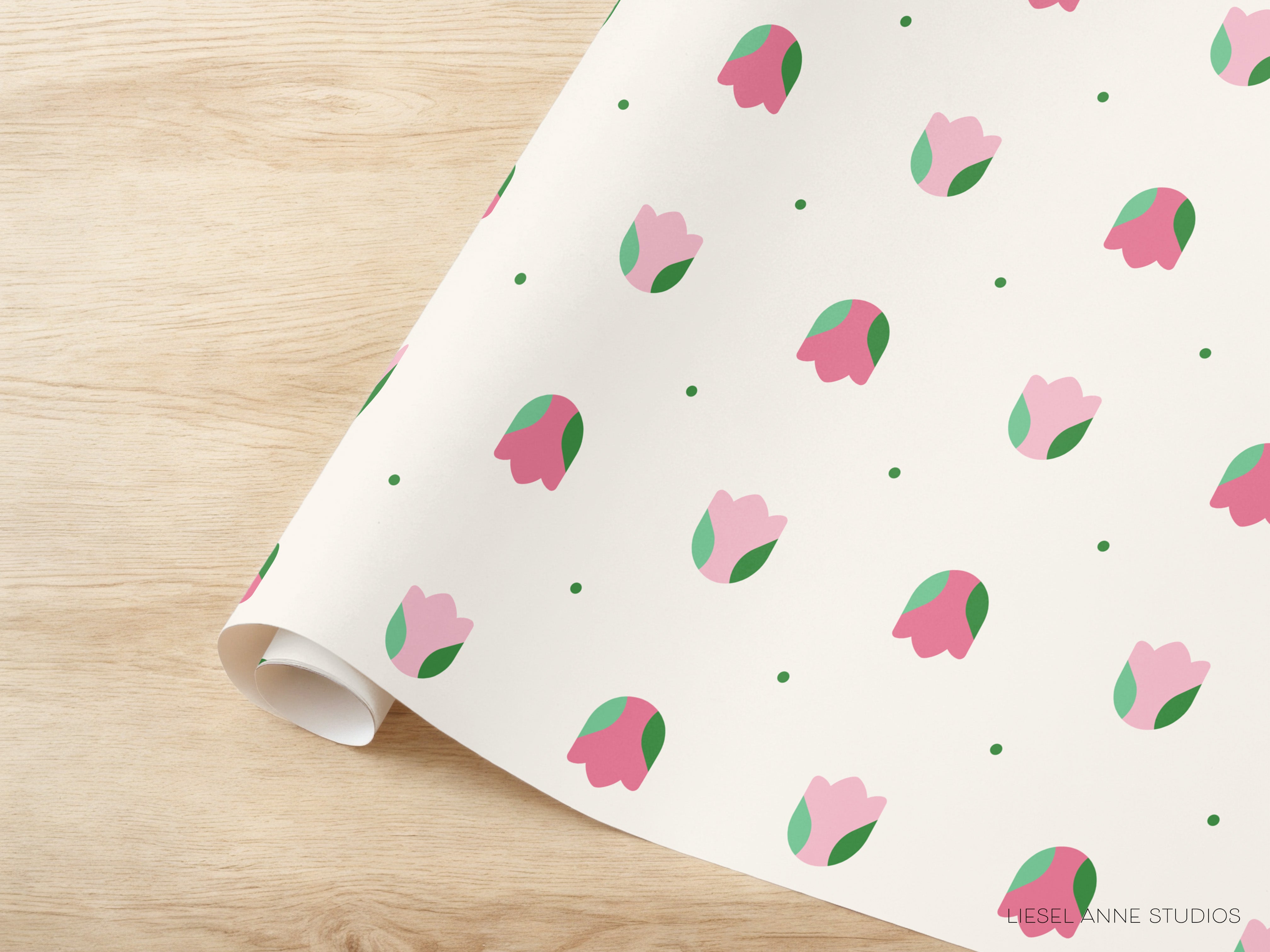 a white paper with a repeating pattern of pink and green flowers or leaves, along with small green dots, creating a visually appealing and playful design.