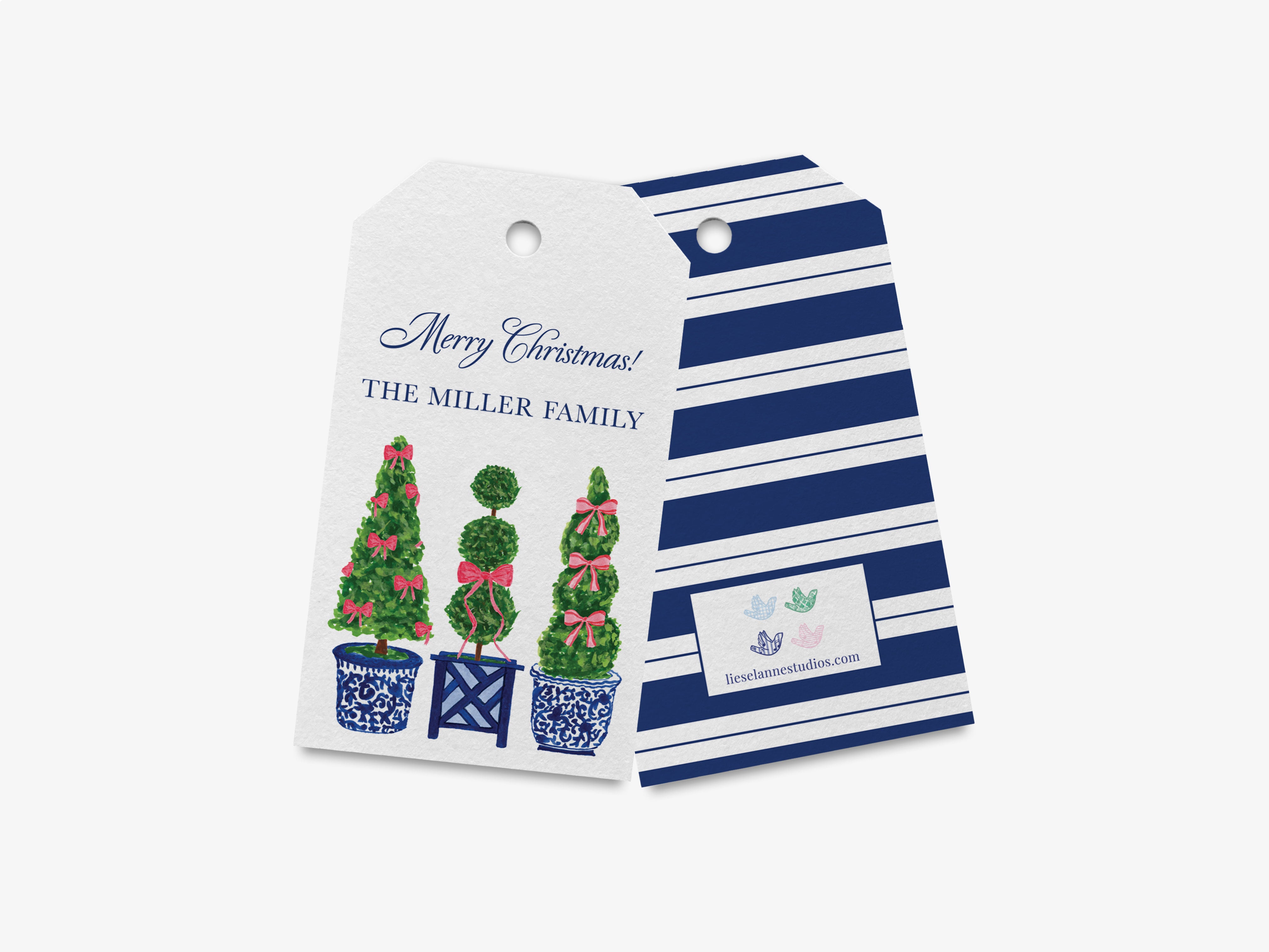 a white tag with a festive design, including three Christmas trees with bows, and a blue and white striped background.