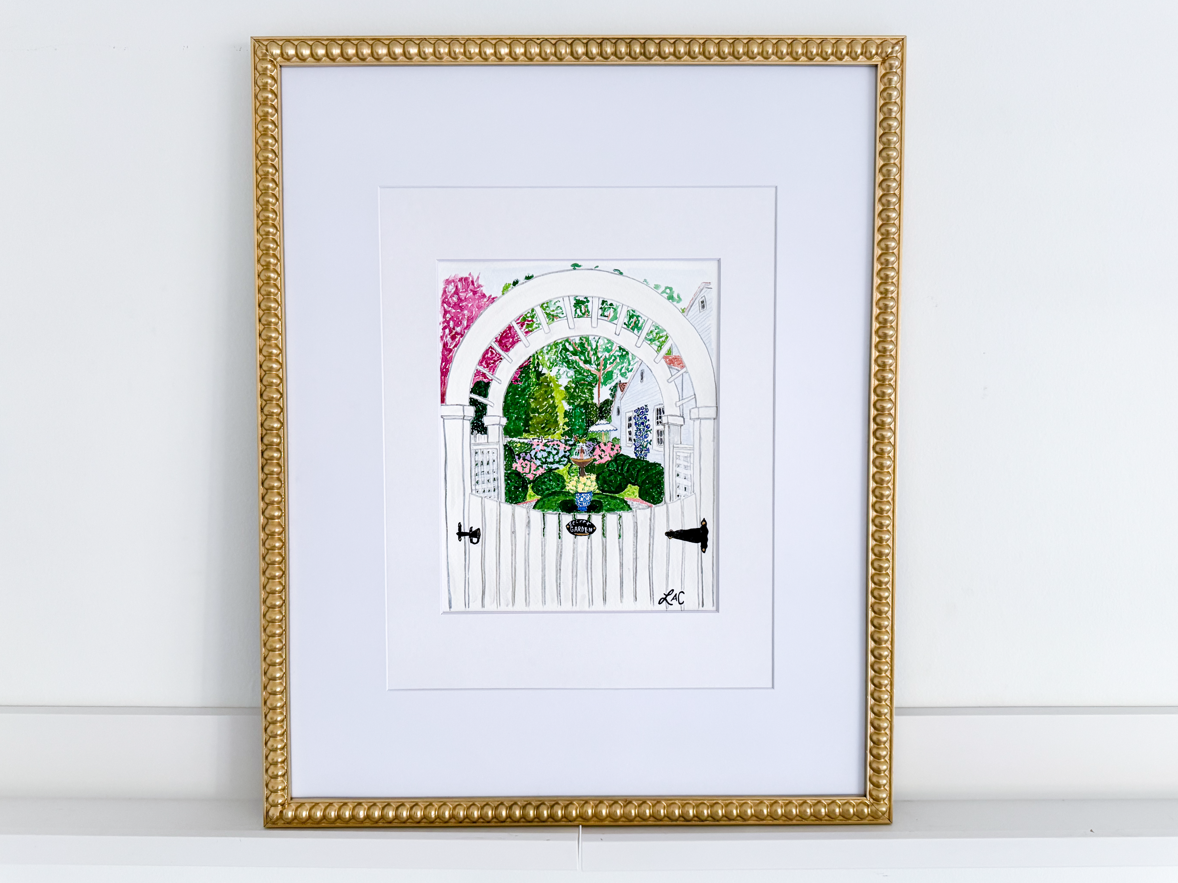 a framed illustration of a white gate with a colorful archway, surrounded by a lush garden scene.