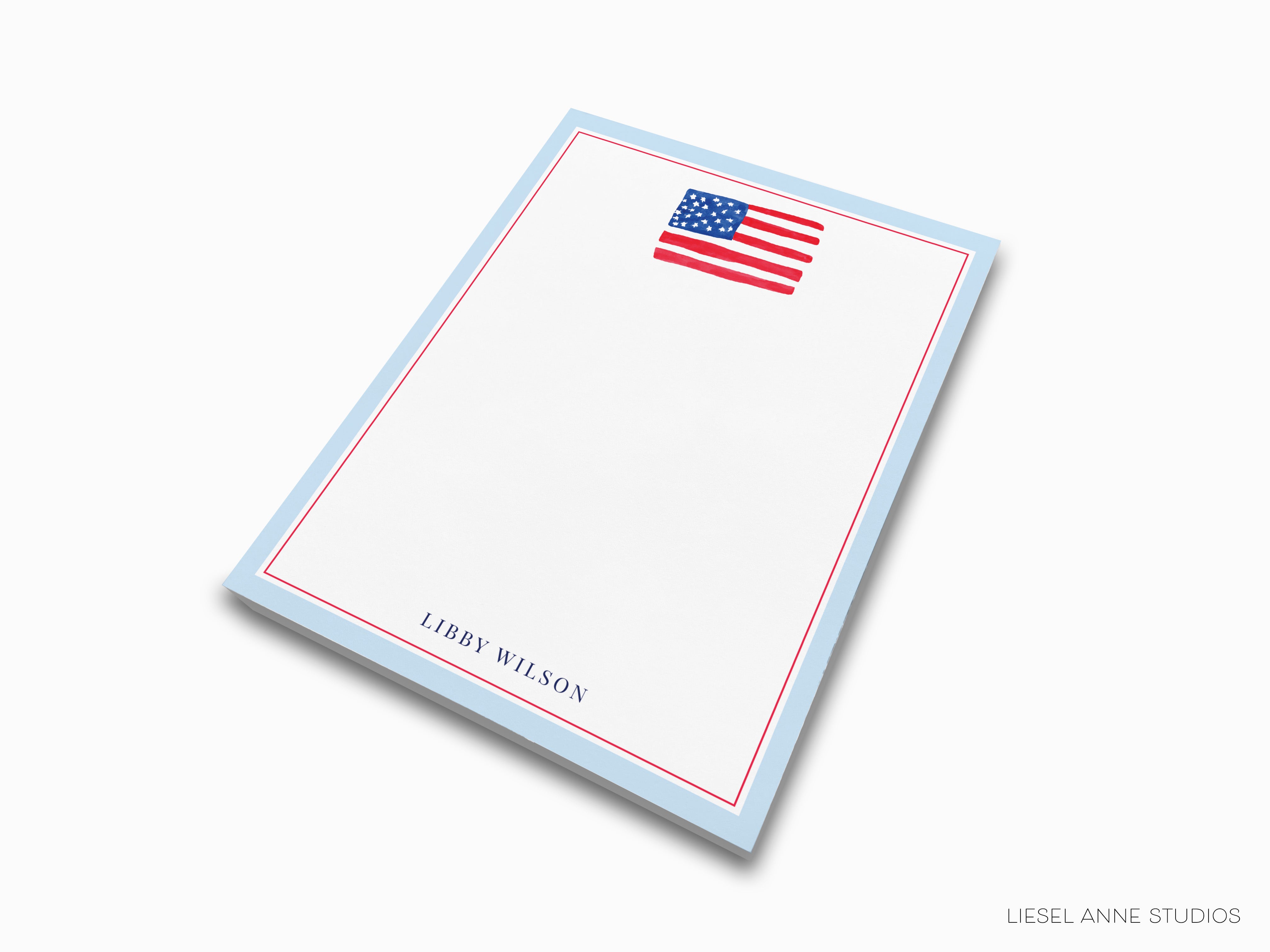 A blank notepad with a blue border and an American flag printed on it.