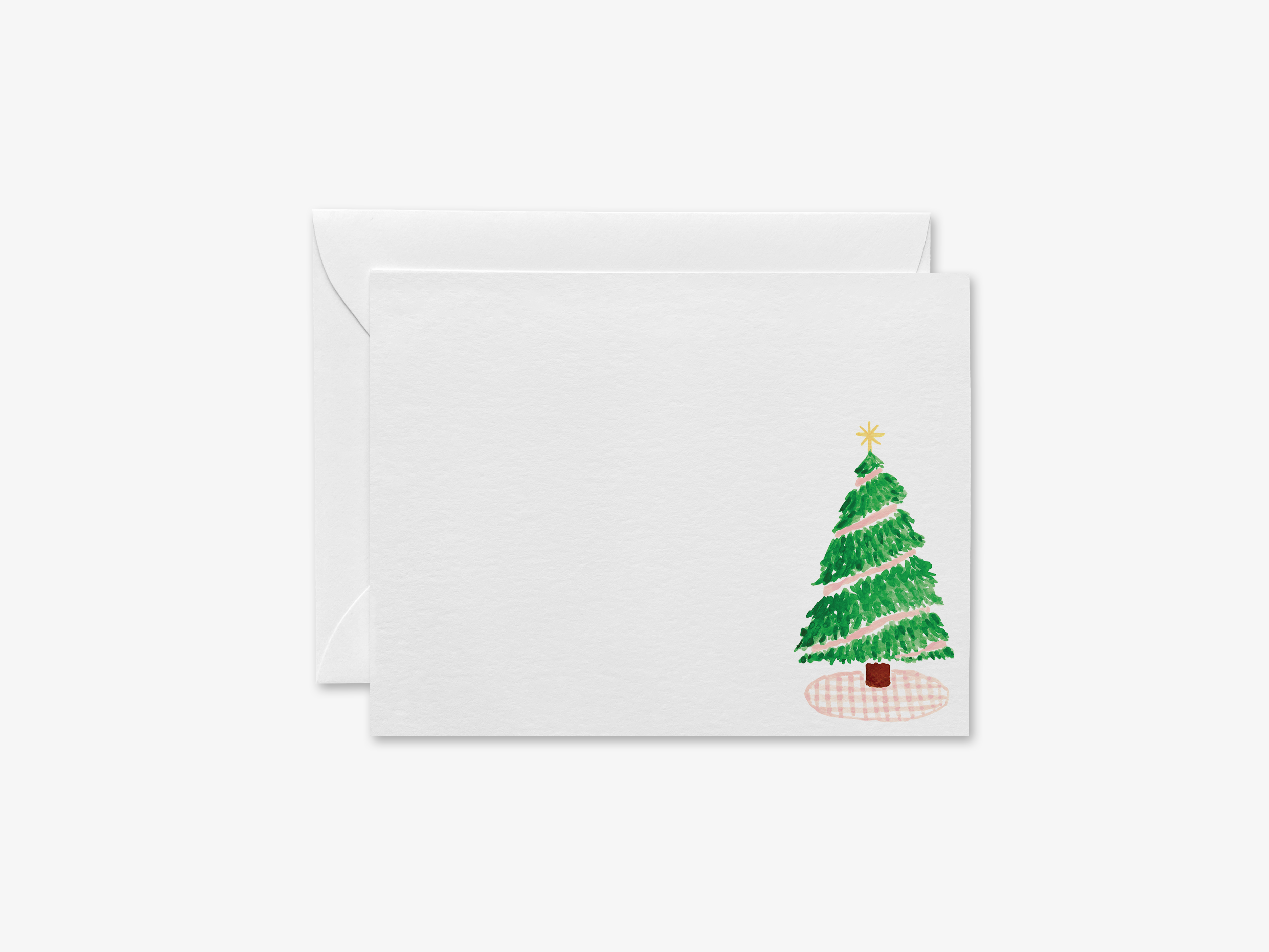 A white greeting card with a Christmas tree illustration on the right side.