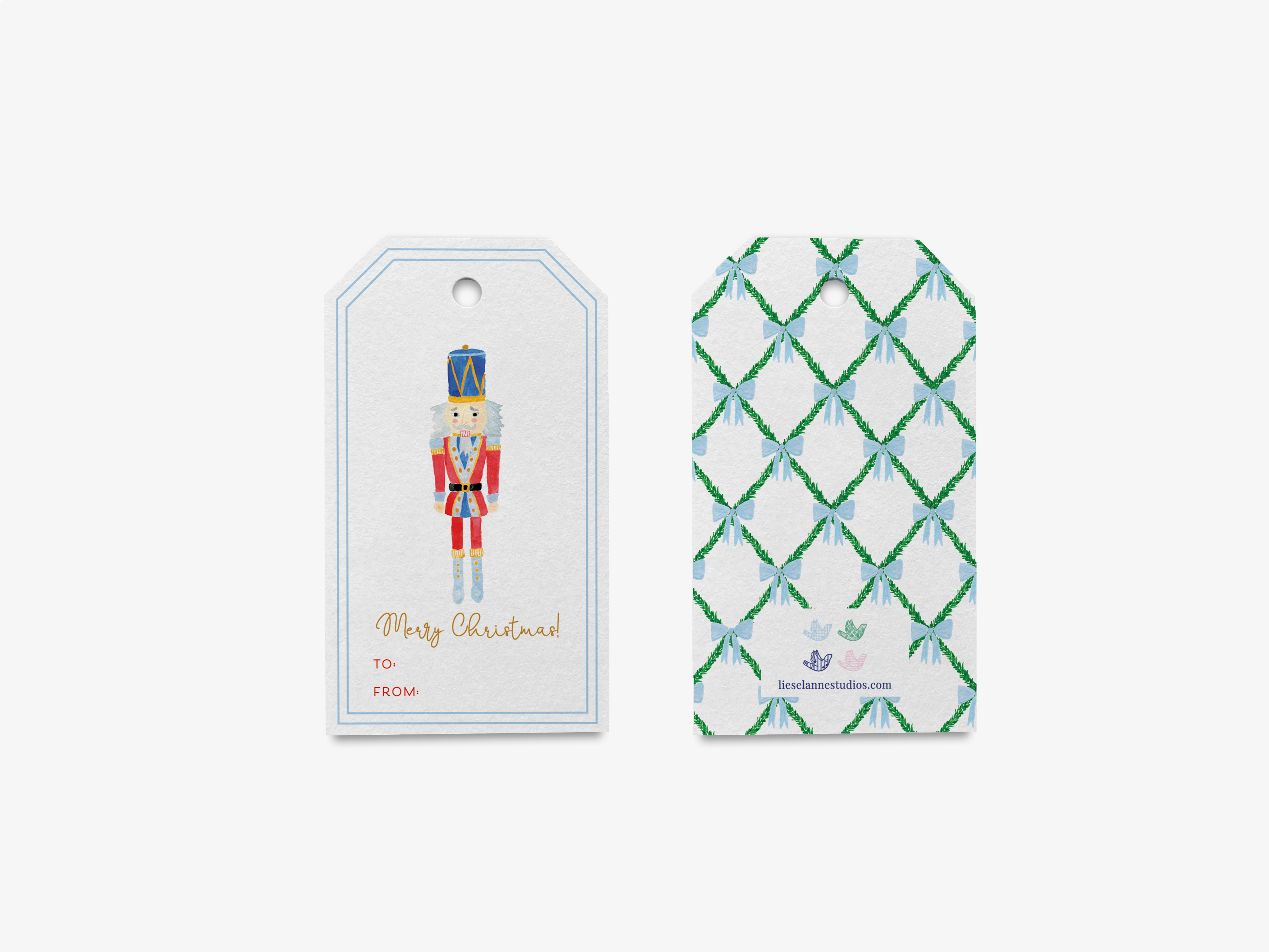 two white tags with Christmas-themed illustrations. The tag on the left features a nutcracker figure, while the tag on the right has a pattern of green and white diamonds.