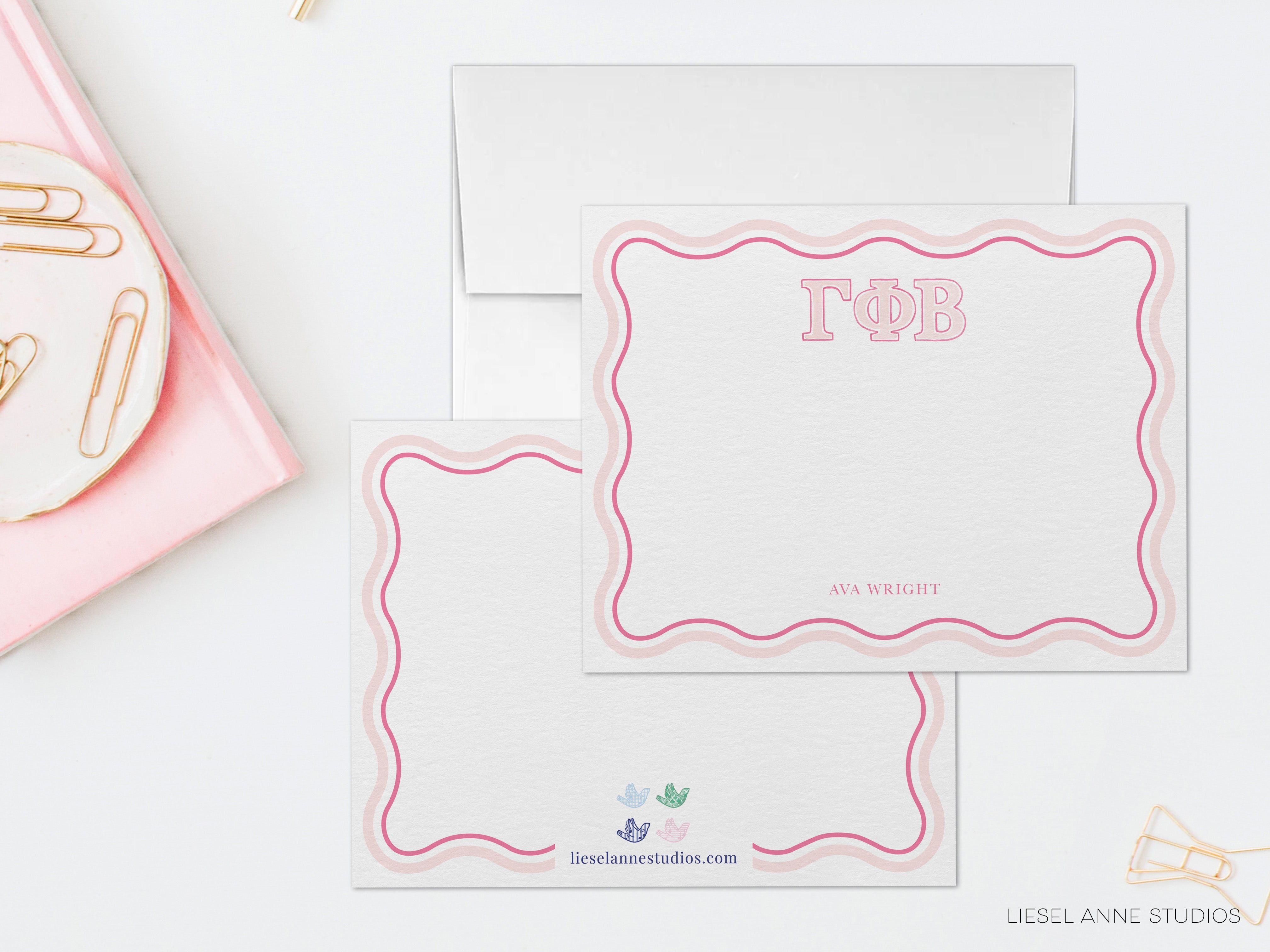 a pink and white stationery set with a name tag