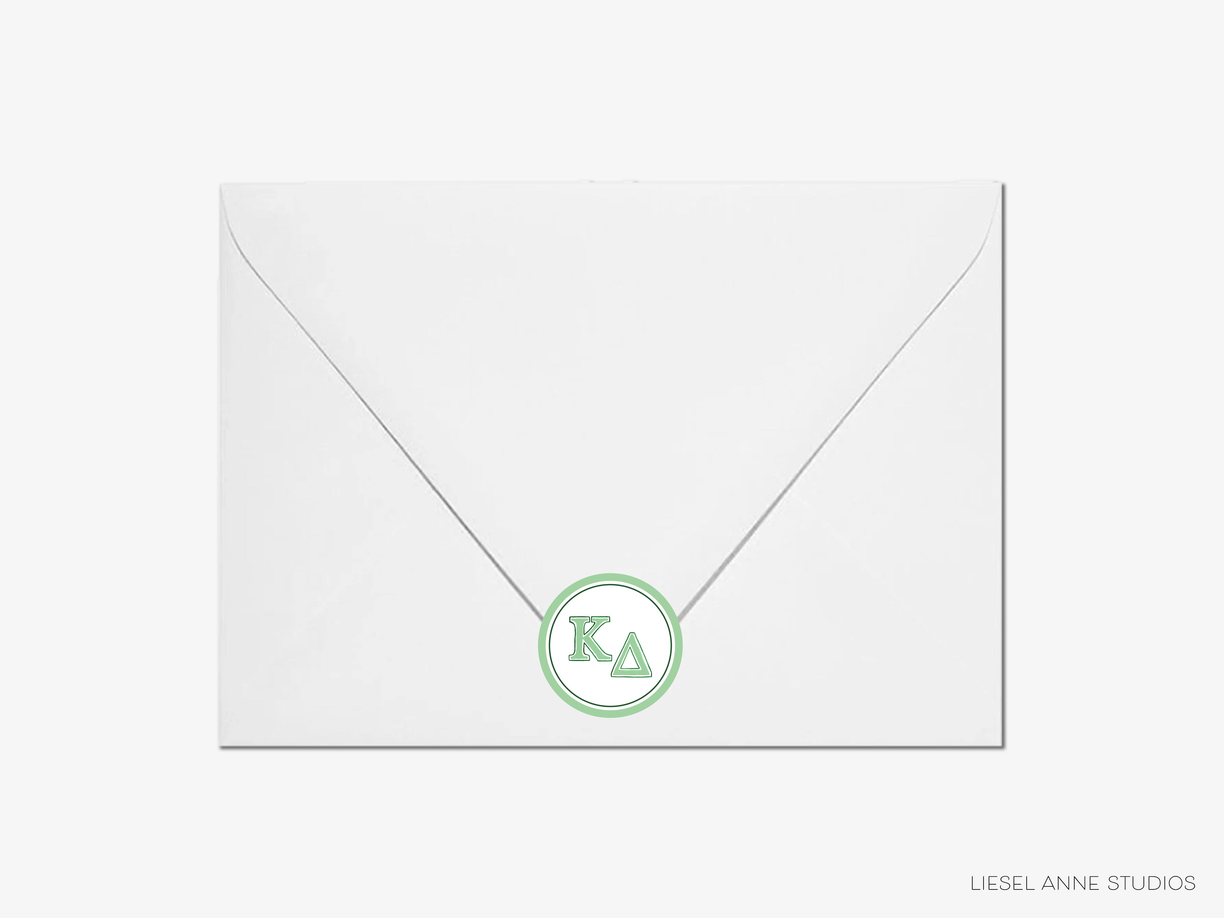 a white envelope with a green letter on it