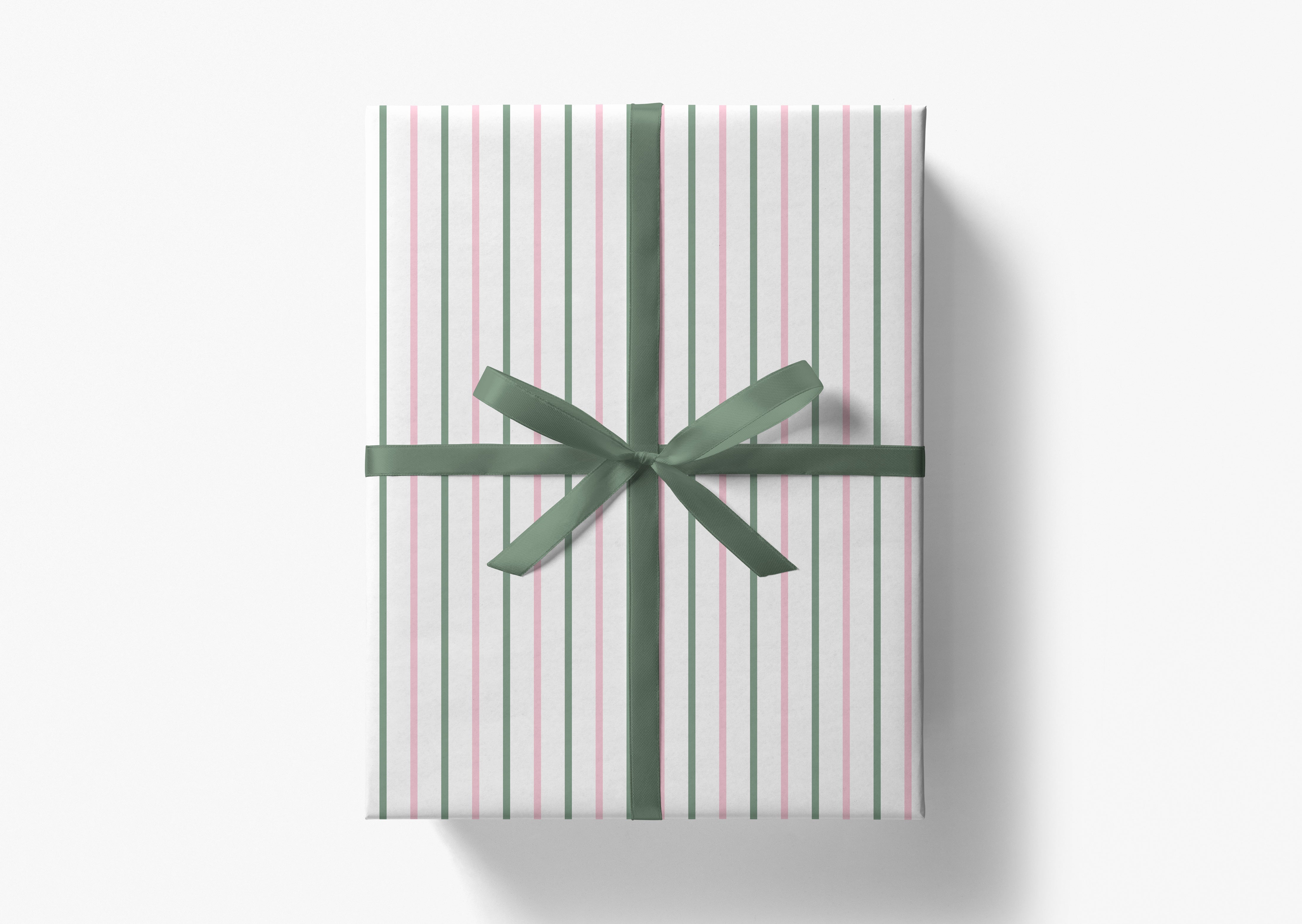 A gift box wrapped in a striped paper with a green ribbon bow tied around it.