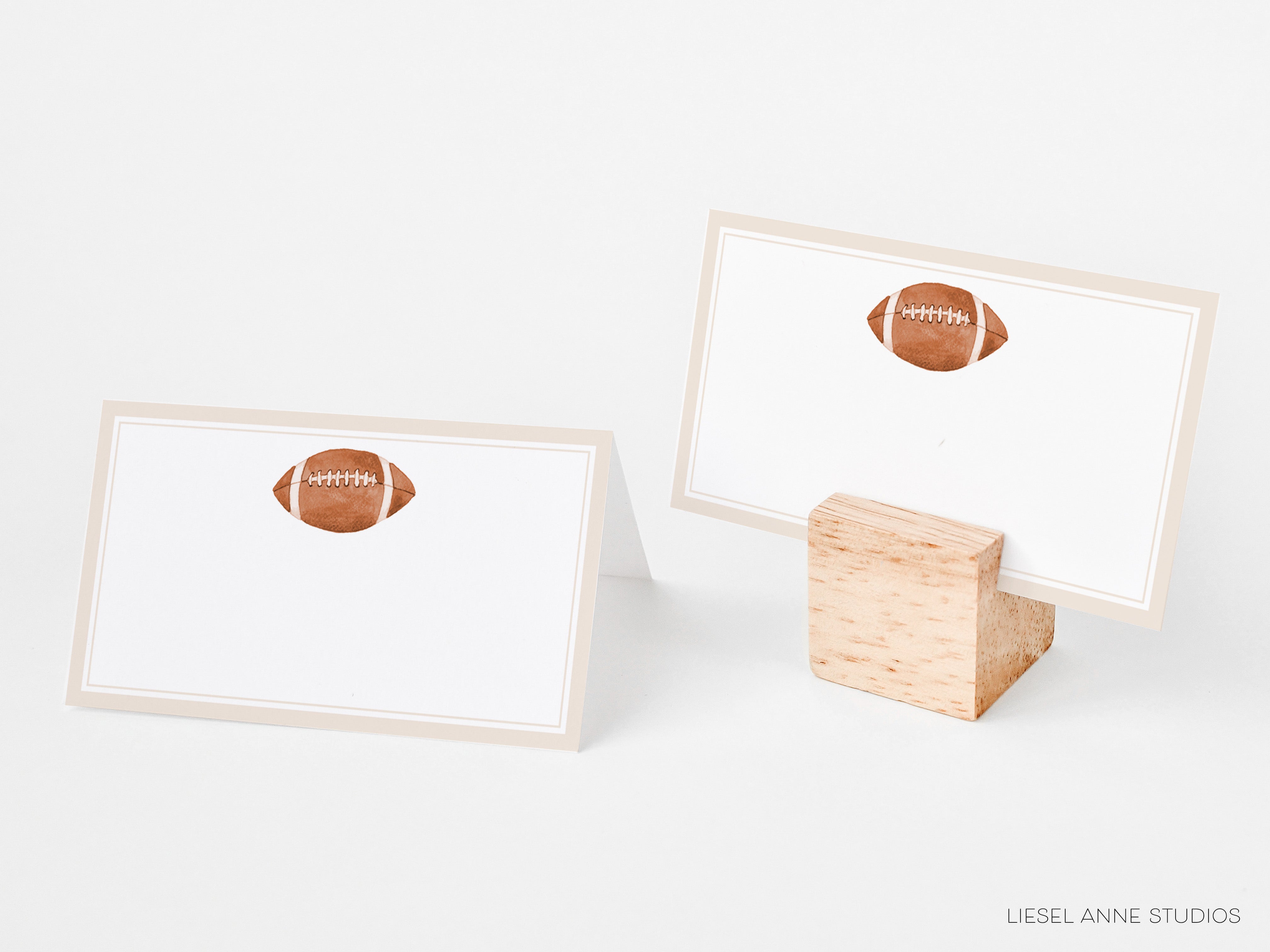 two blank place cards with a football design on them, placed on a white background.