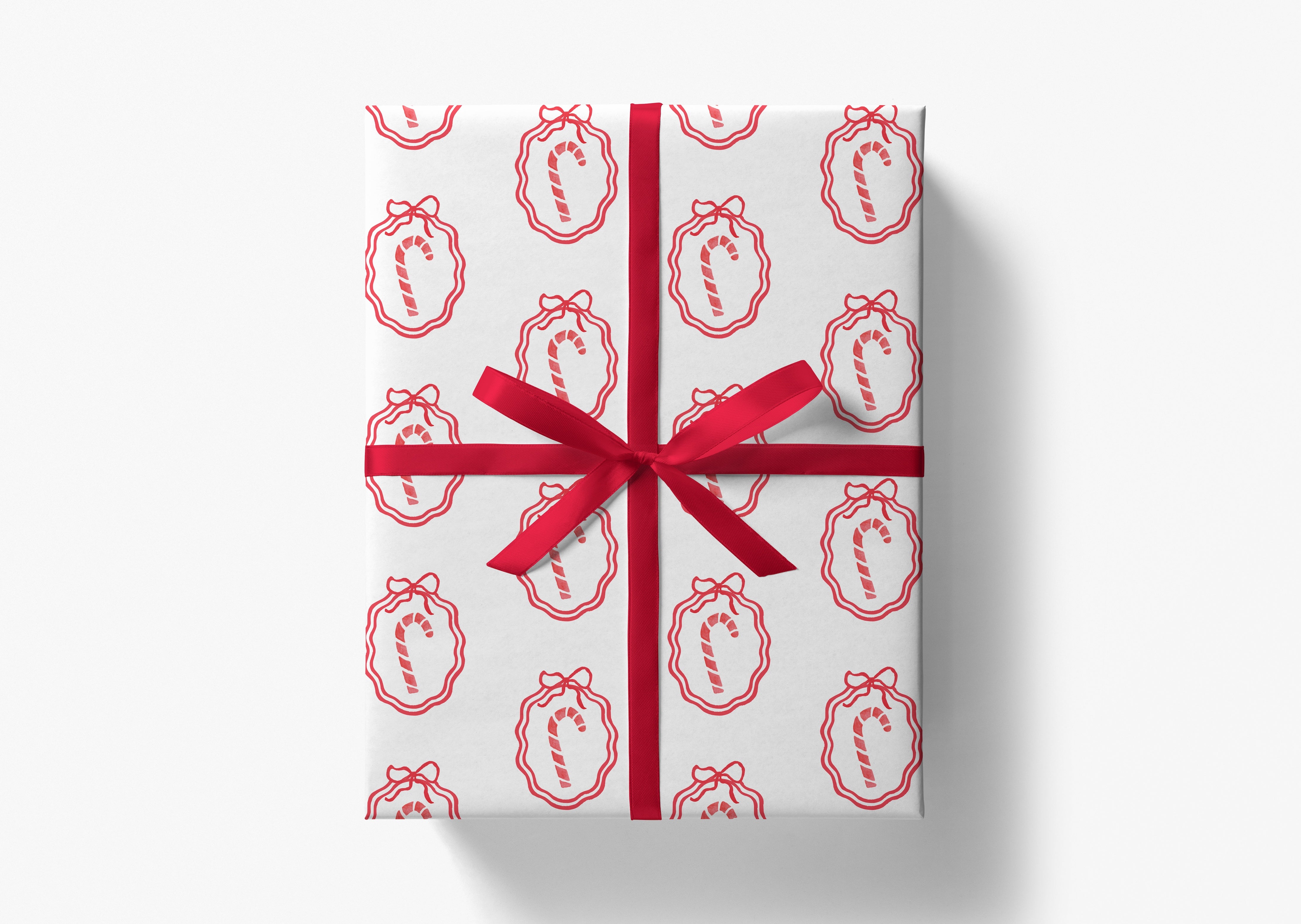 a gift box wrapped in a red ribbon with a repeating pattern of red and white candy canes on the wrapping paper.