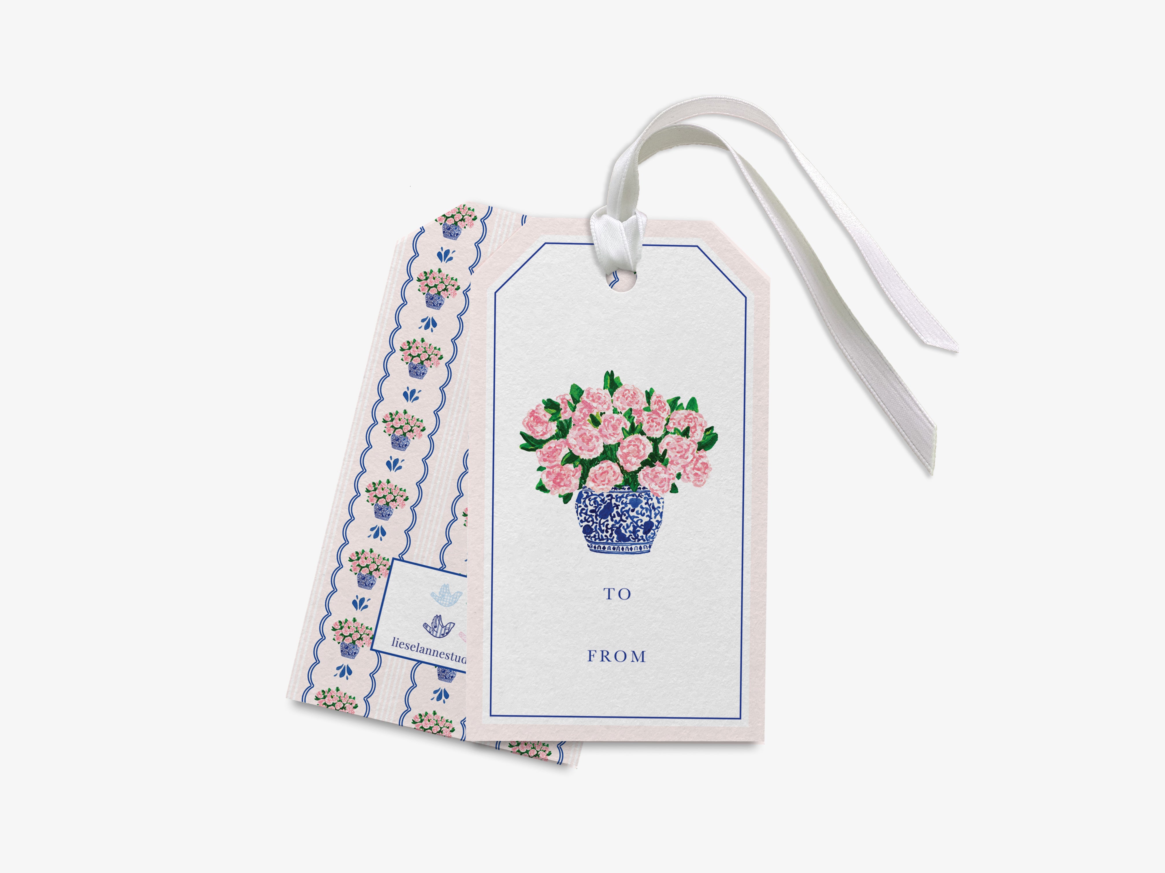 a white tag with pink flowers on it