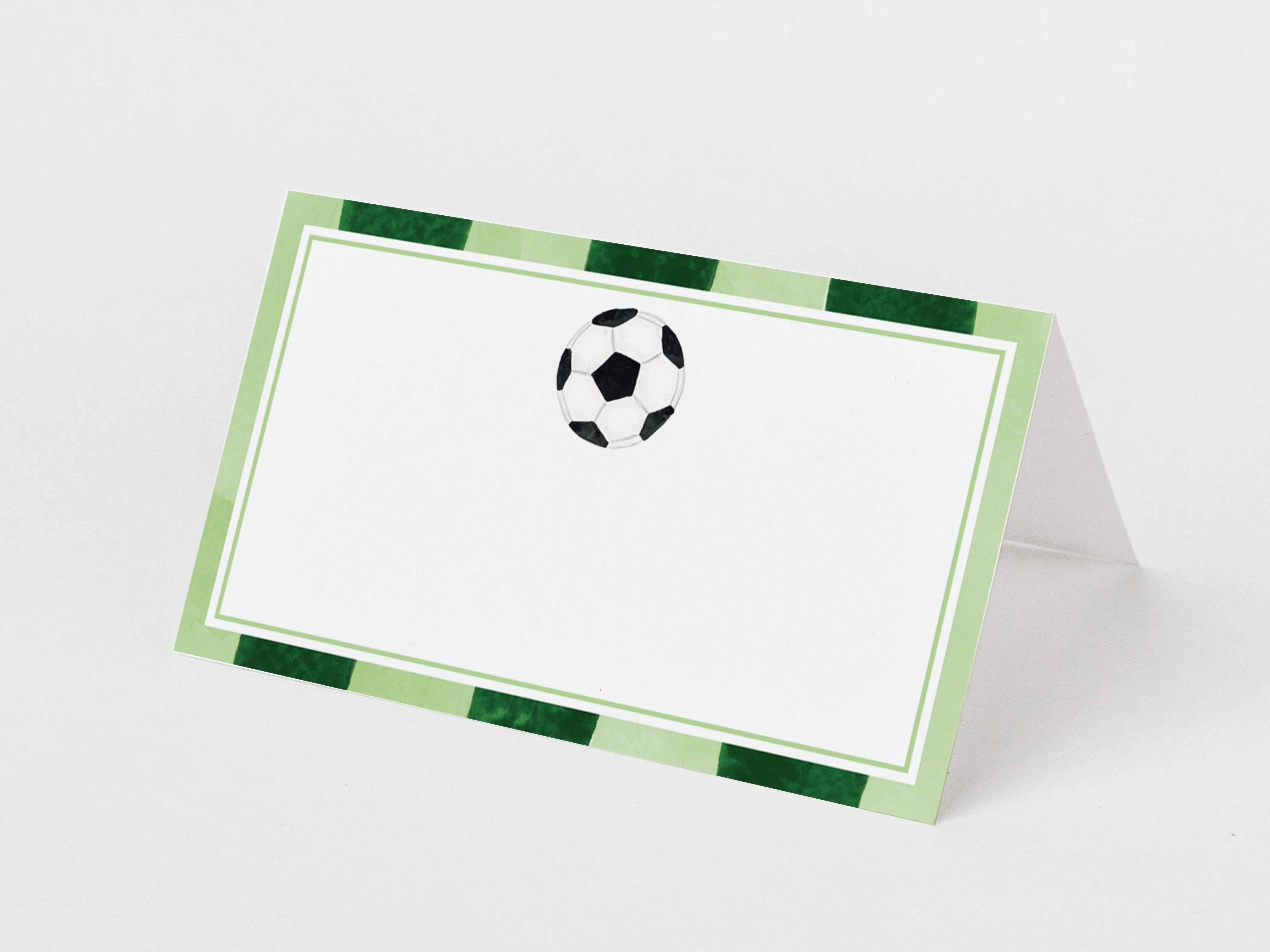 a green and white card with a soccer ball design on it.