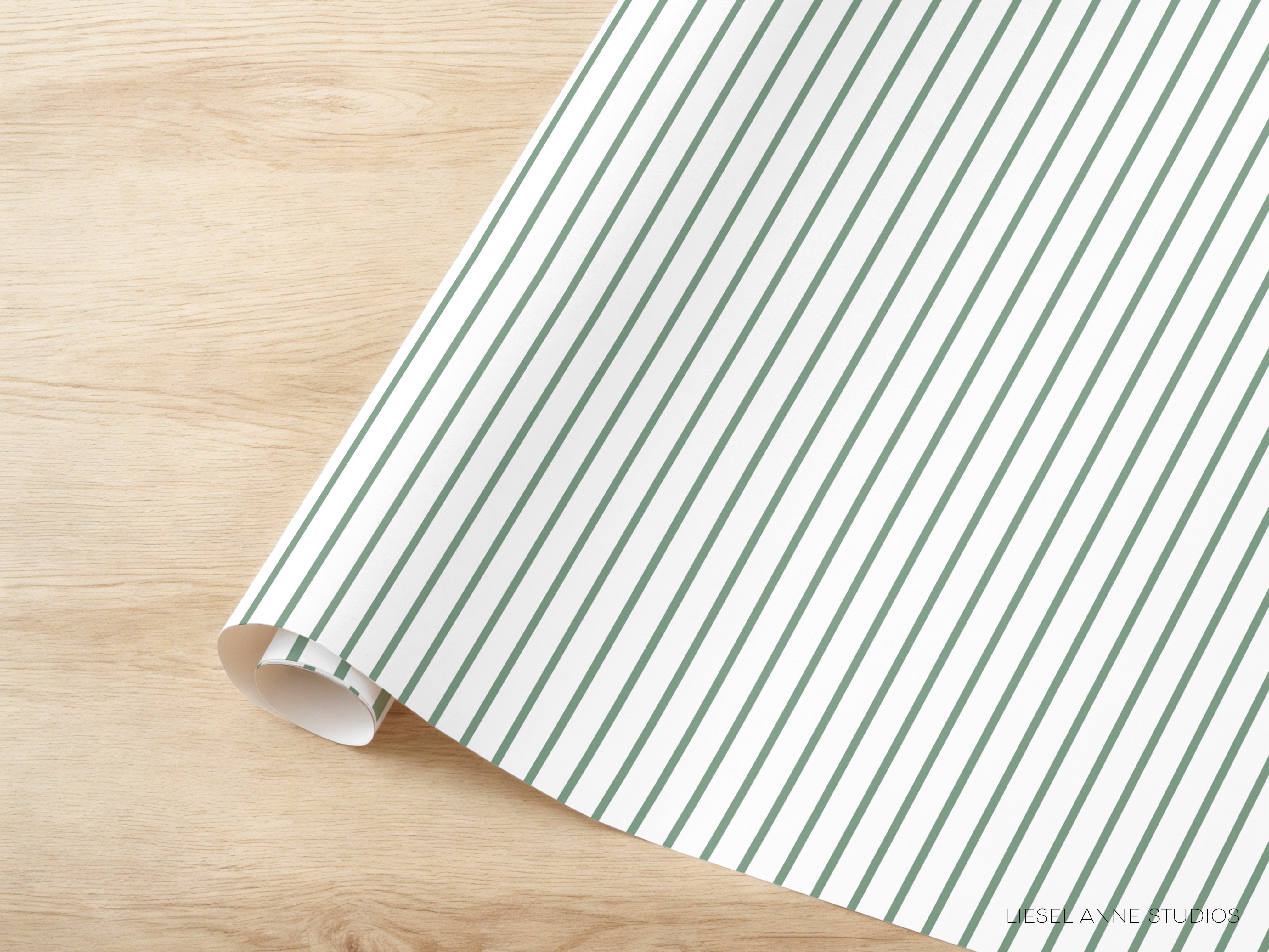 A roll of white and green striped paper is placed on a wooden surface.