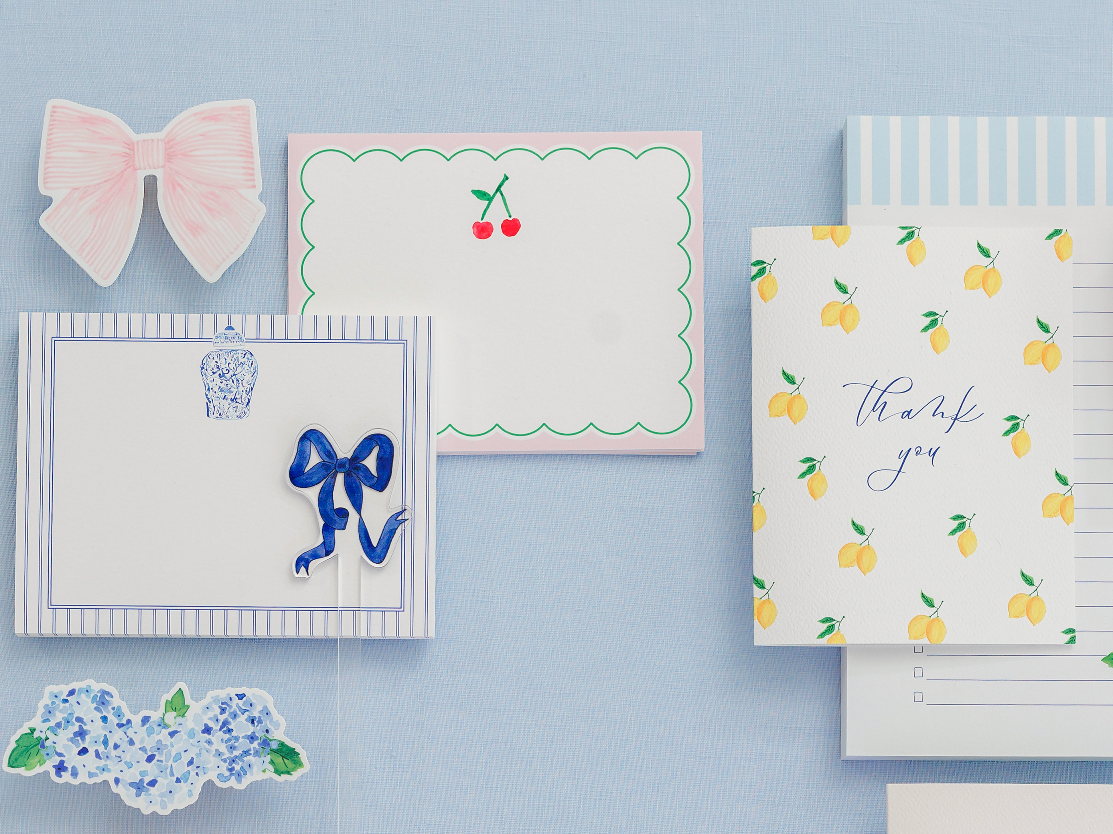 various decorative elements, including a bow, a card with a lemon pattern, and a blank card.