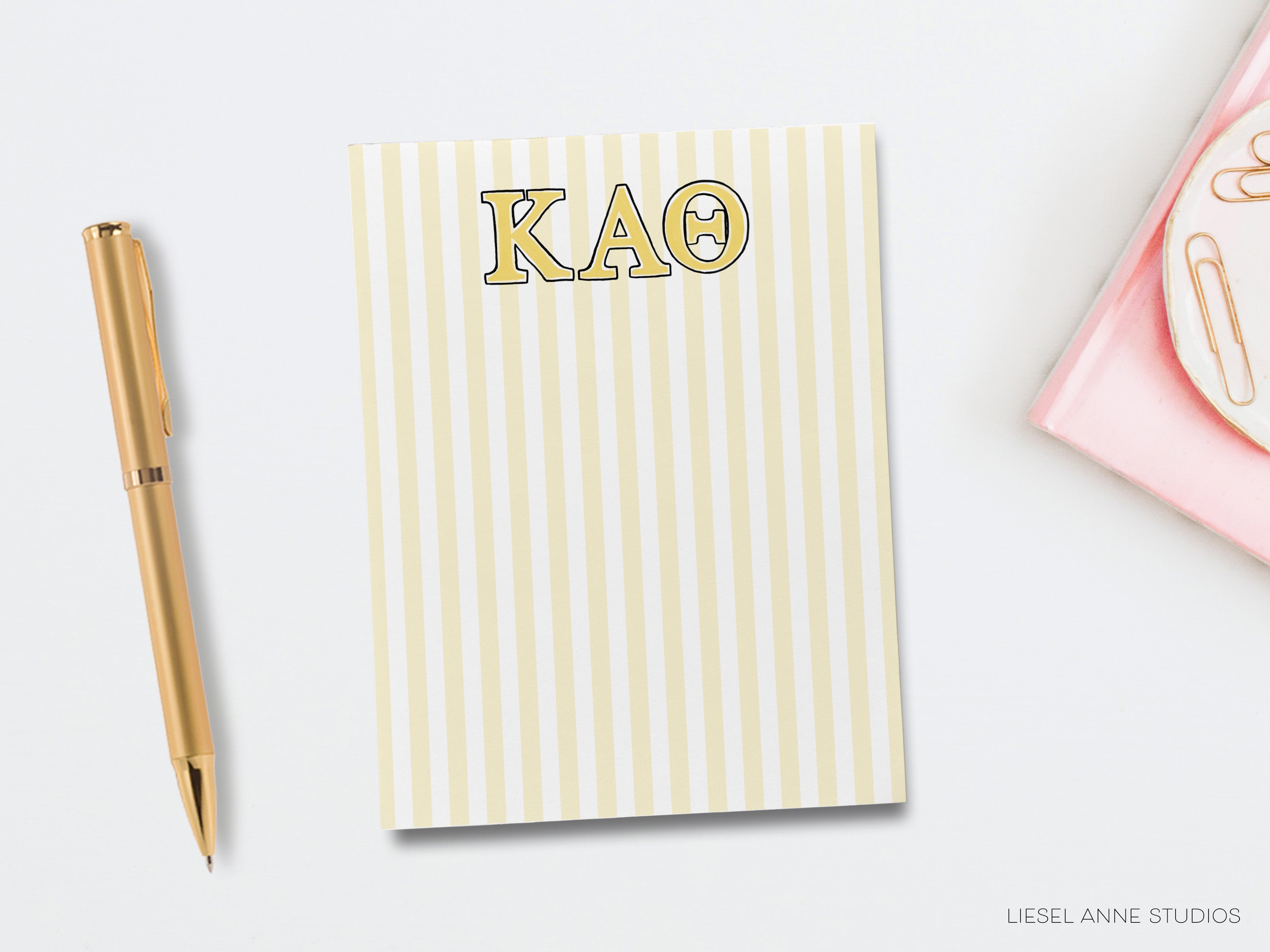 a notepad with the word kaq on it next to a pen