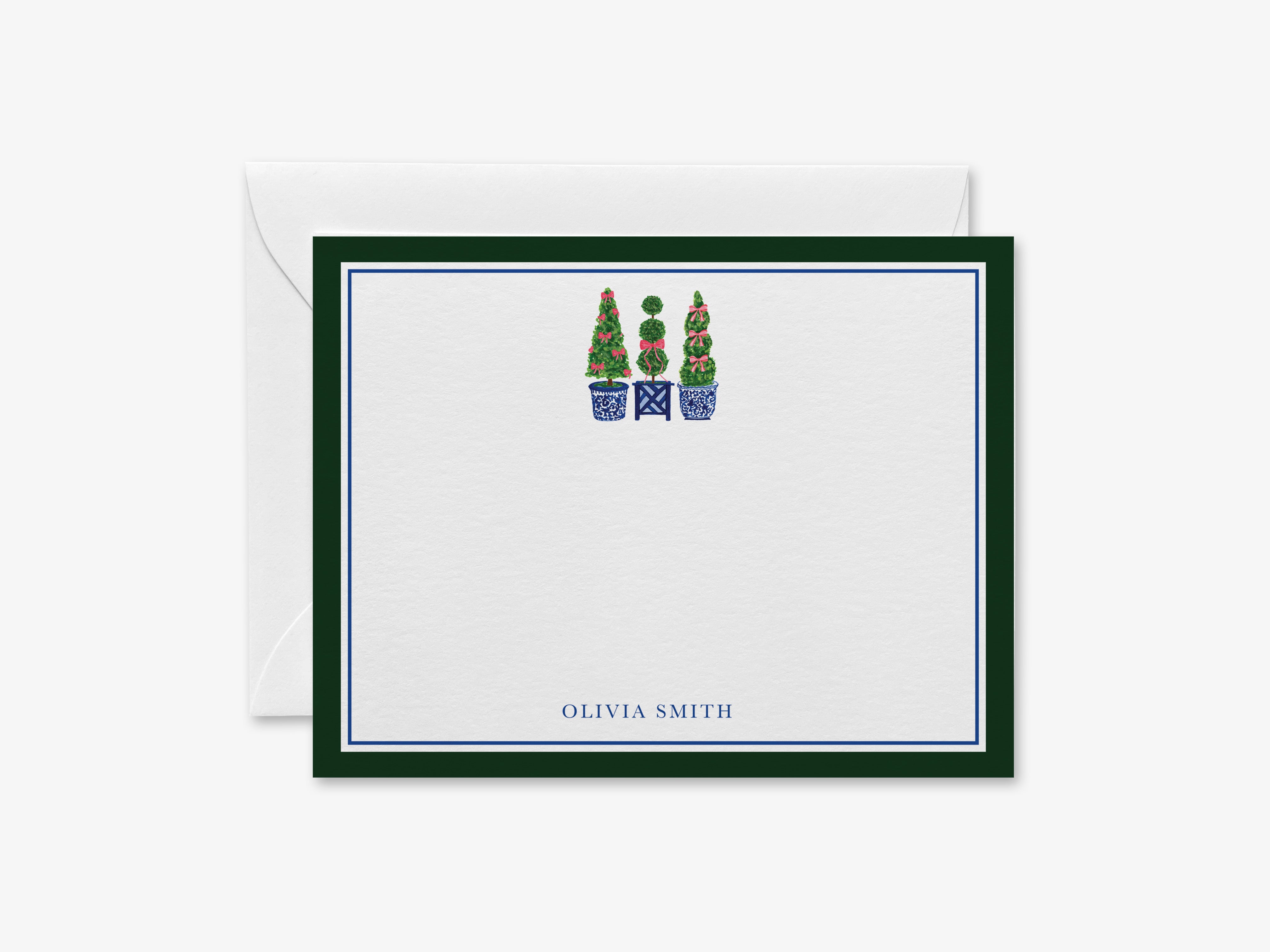 a personalized stationery card with a green border and a white background. The card has a blue border and a graphic of three topiary trees in blue pots. The name 'OLIVIA SMITH' is written in the bottom right corner of the card.